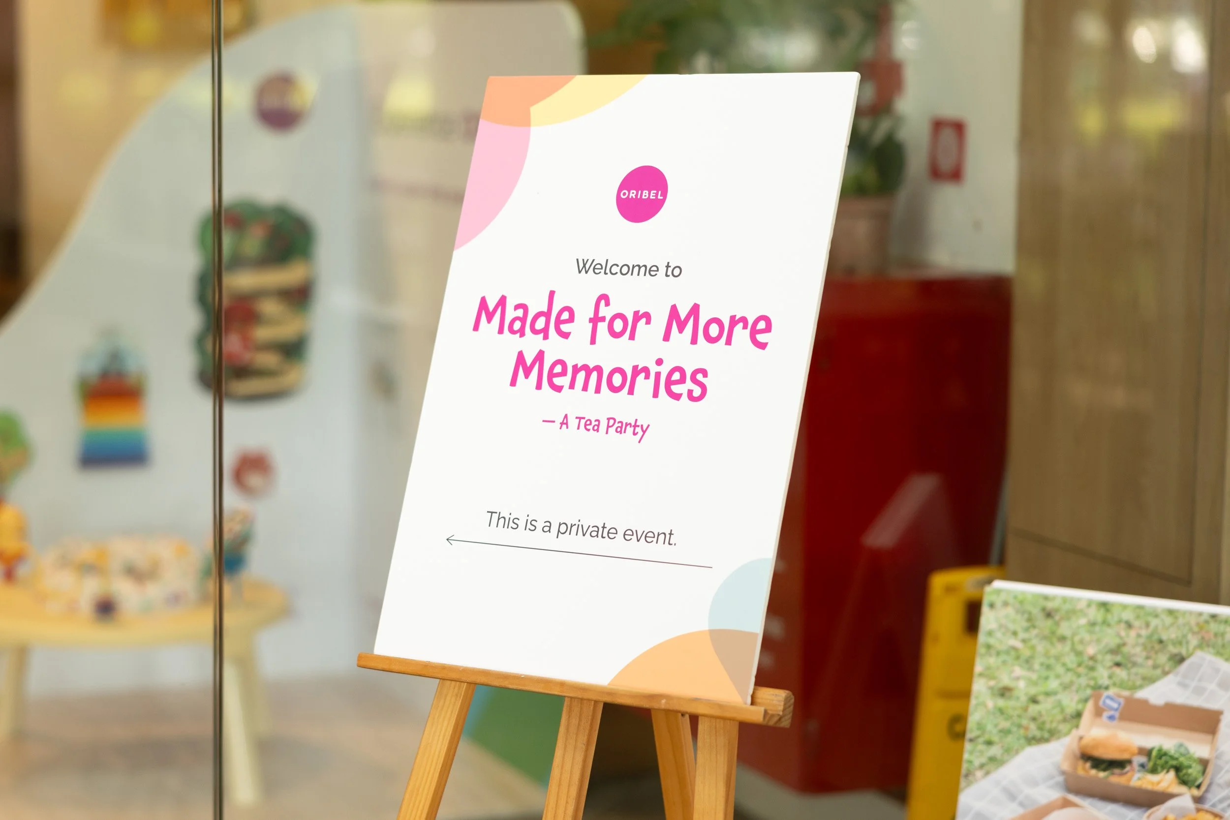  Printed event sign reading "Made for More Memories - A Tea Party" at the venue entrance. 