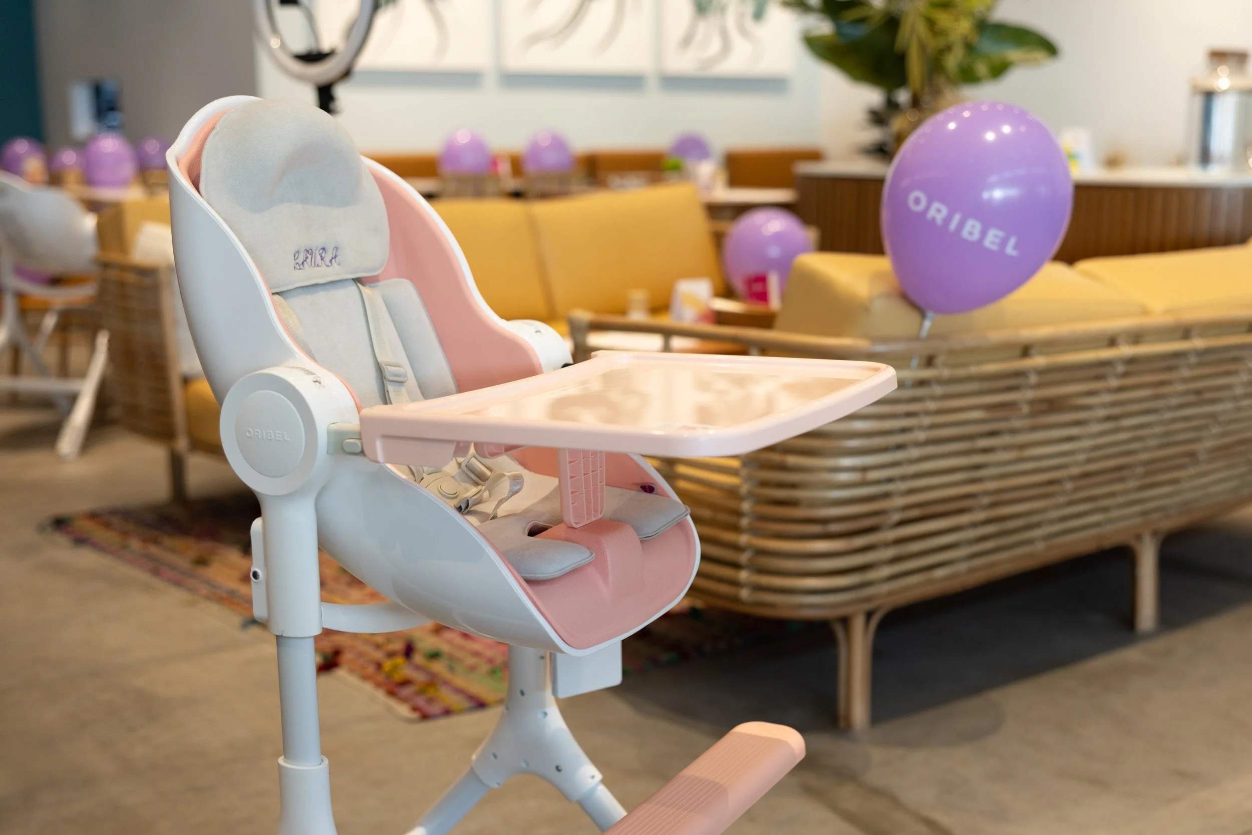  Detail shot of a pink Oribel Cocoon high chair displayed at the event space. 