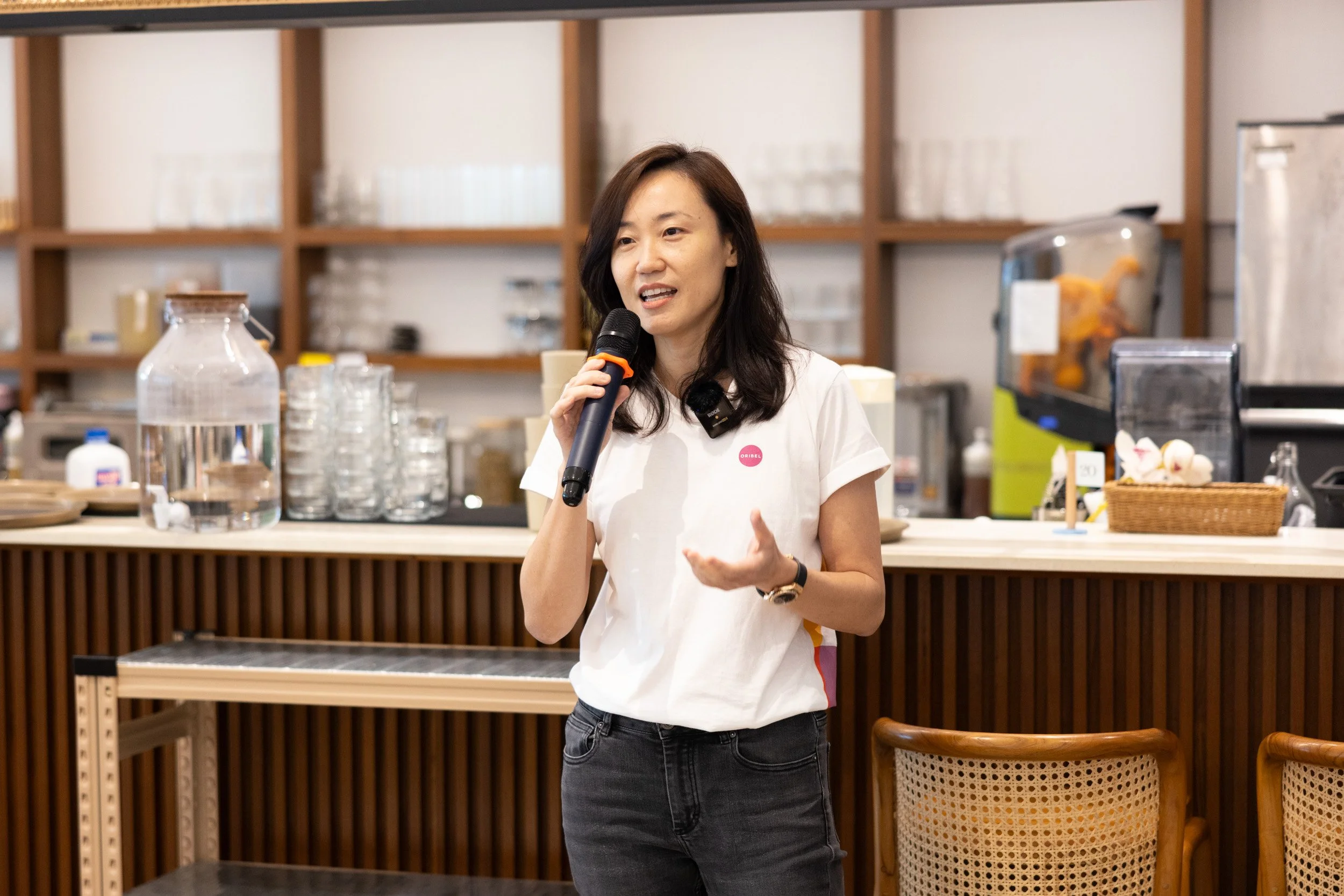  Close-up photo of Oribel founder Cindy Goh speaking to attendees during the event. 