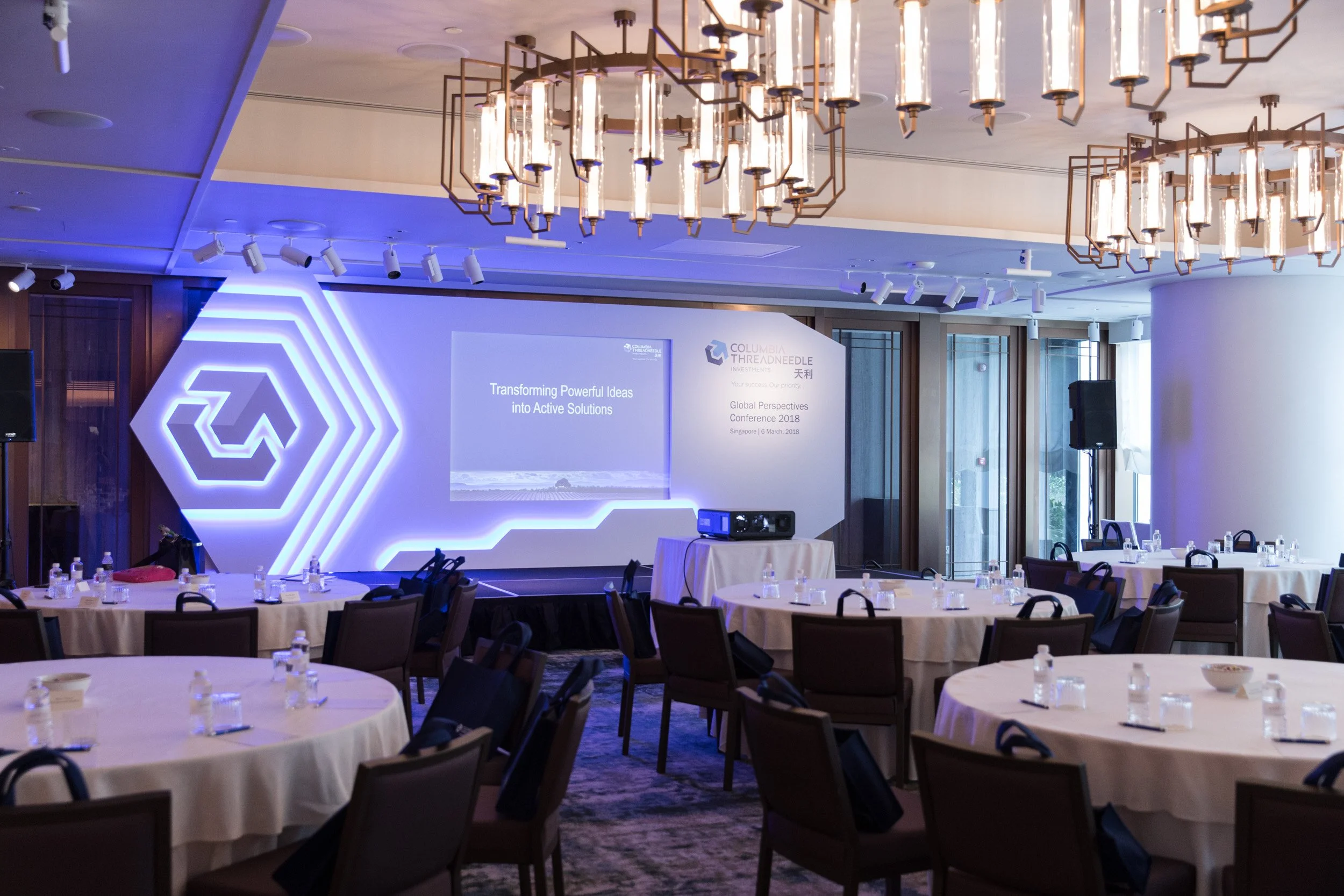  Wide-angle view of the ballroom setup at Andaz Singapore with corporate stage branding prior to guest arrival. 