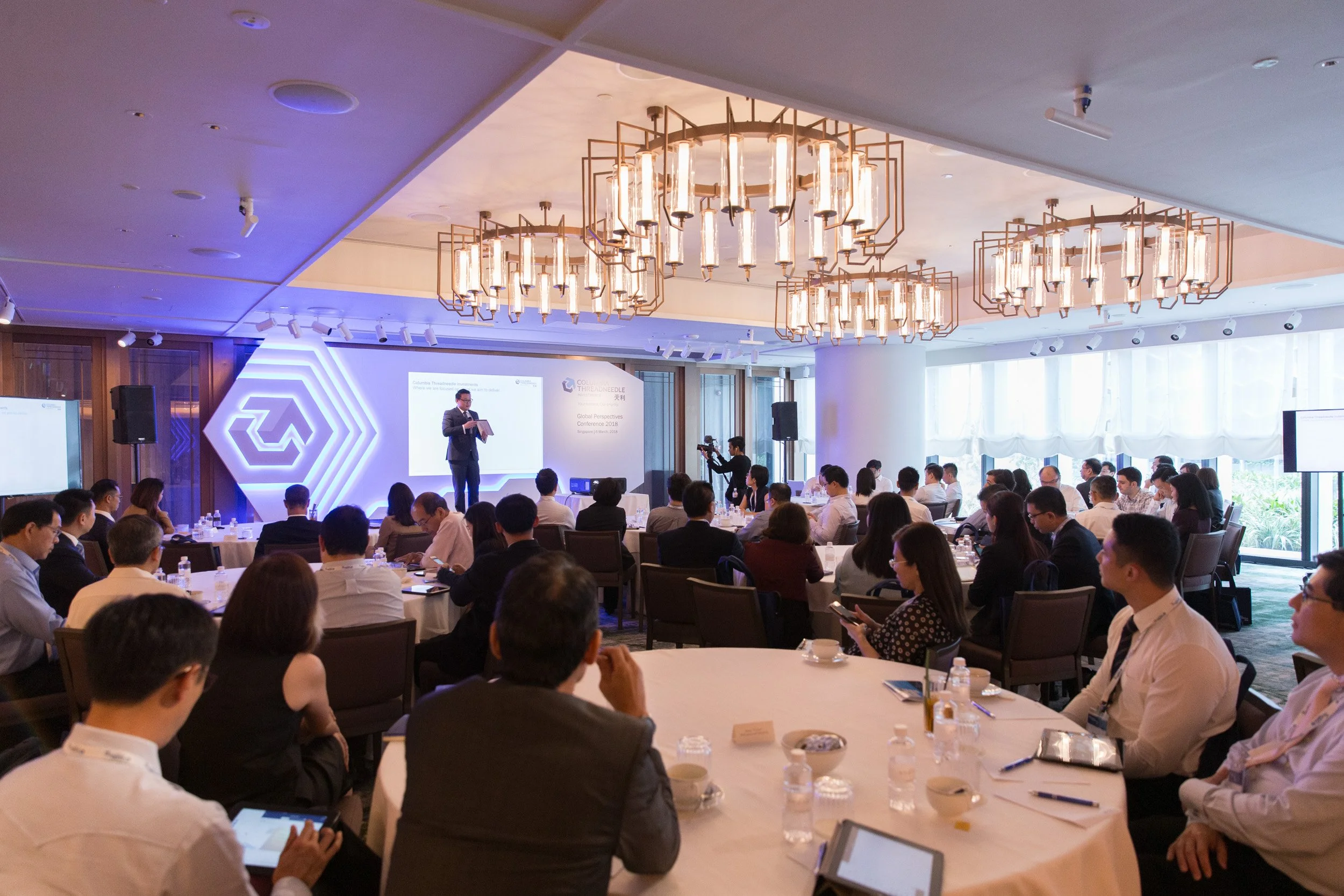  Keynote speaker delivering a financial market presentation on stage at Garden Studio. 