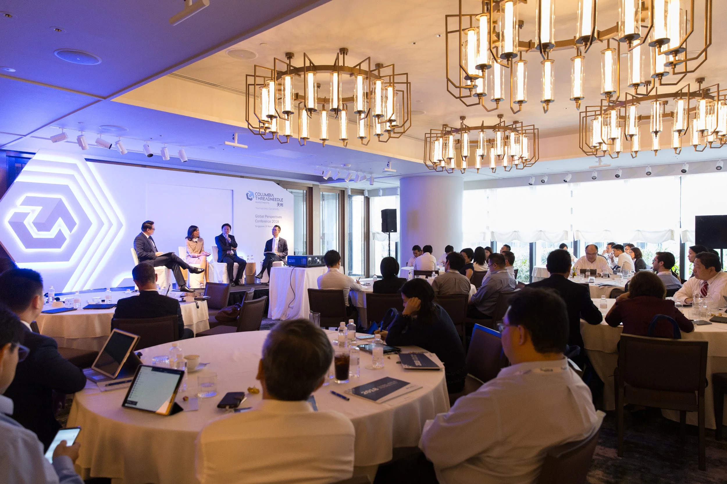  Wide-angle shot of the executive panel discussion stage during the Q&amp;A segment. 