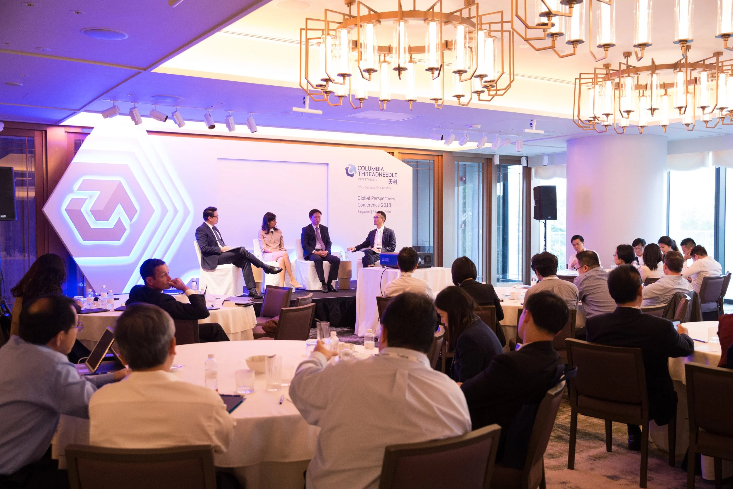  Perspective shot of financial leaders participating in a roundtable panel discussion. 