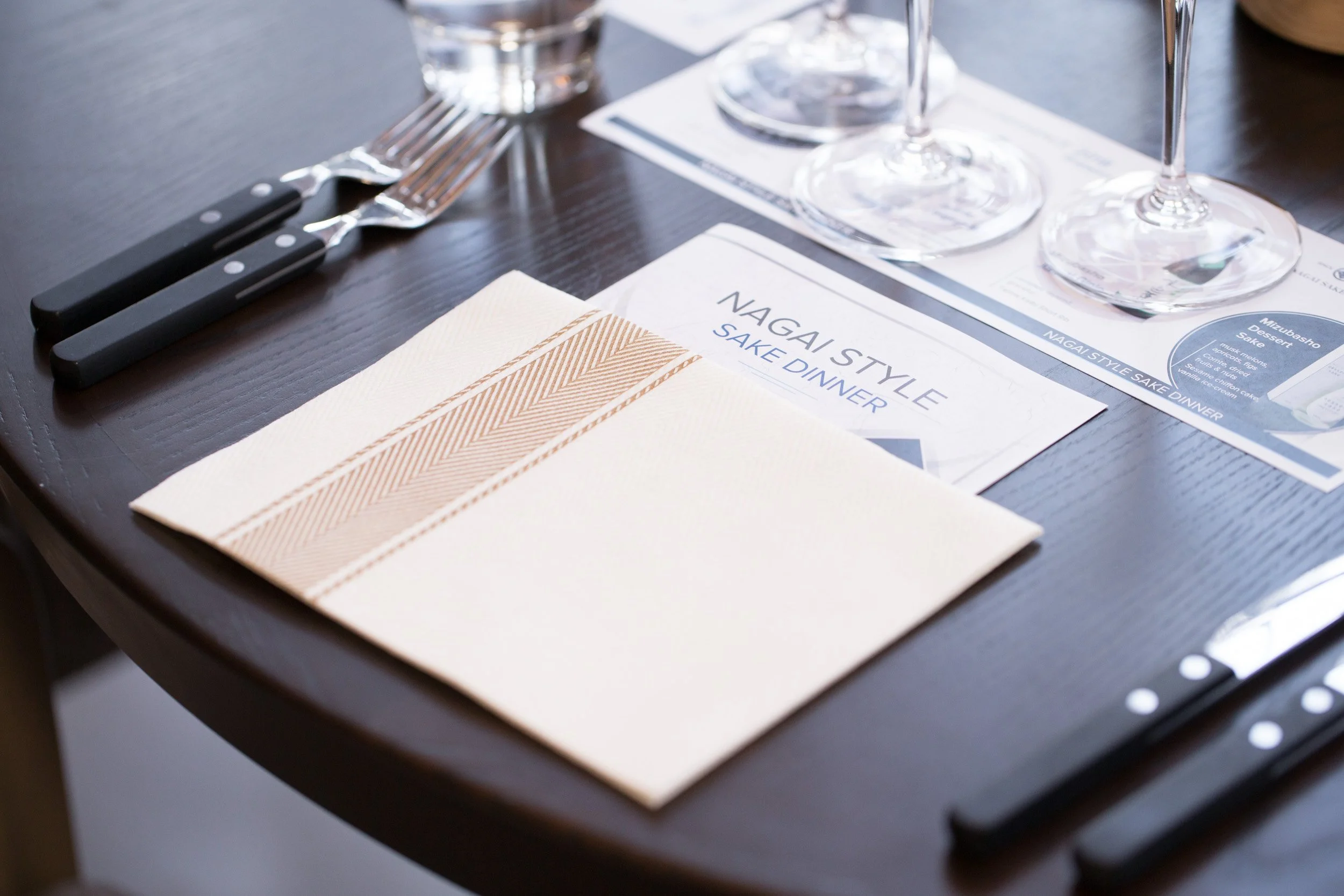  Close-up table setting with folded napkins and utensils for the evening dinner at Smoke &amp; Pepper. 