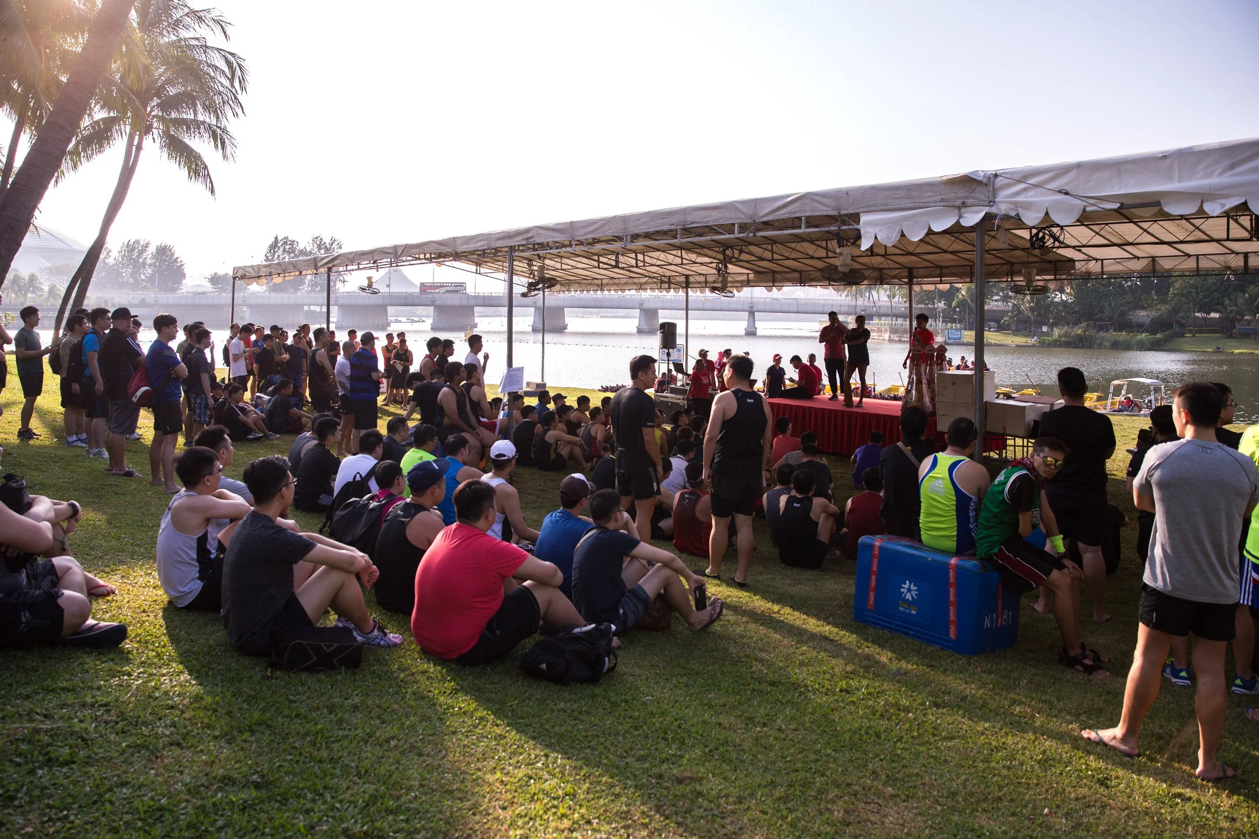  Briefing session stage with instructors demonstrating dragon boat paddling technique to participants. 