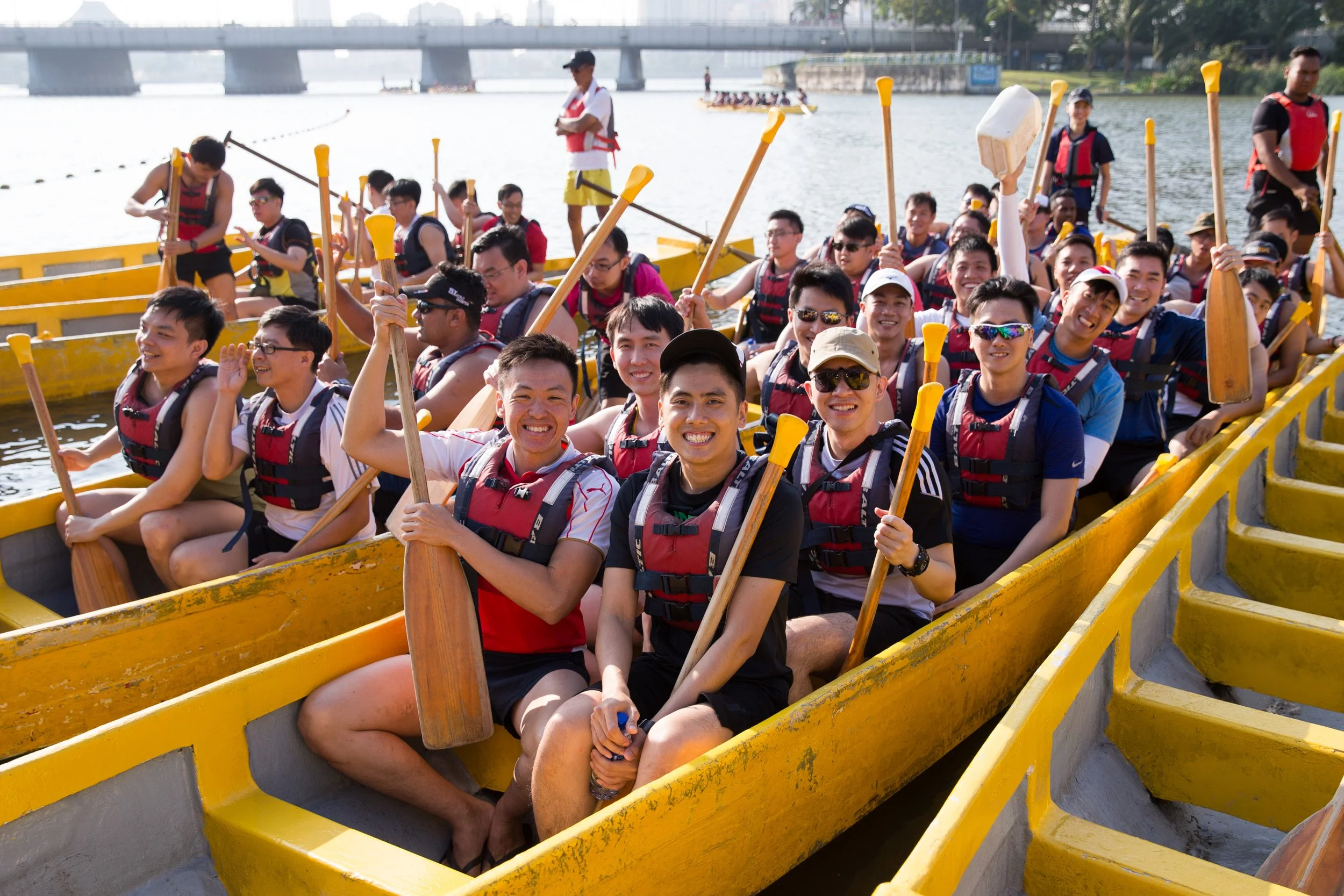  Group shot of Singapore Artillery personnel wearing life jackets on dragon boats prepared to launch. 