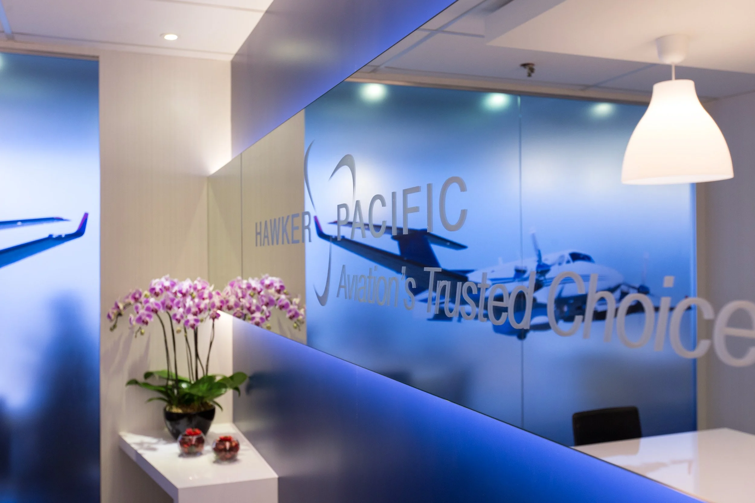  Interior close-up of printed Hawker Pacific logo on mirrored glass inside the chalet VIP meeting room. 
