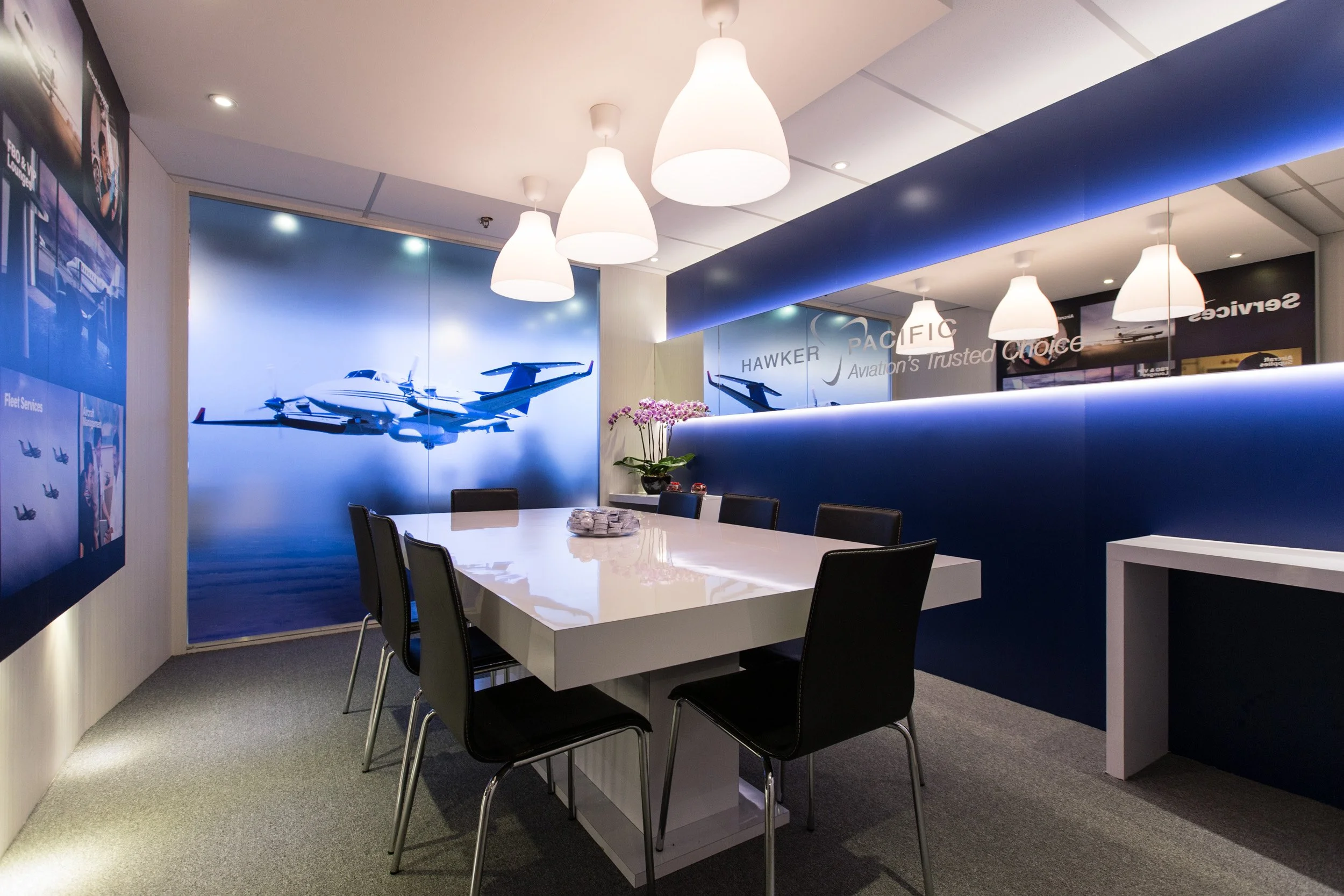  Modern executive meeting room setup with conference table and seating inside Hawker Pacific Hospitality Chalet. 