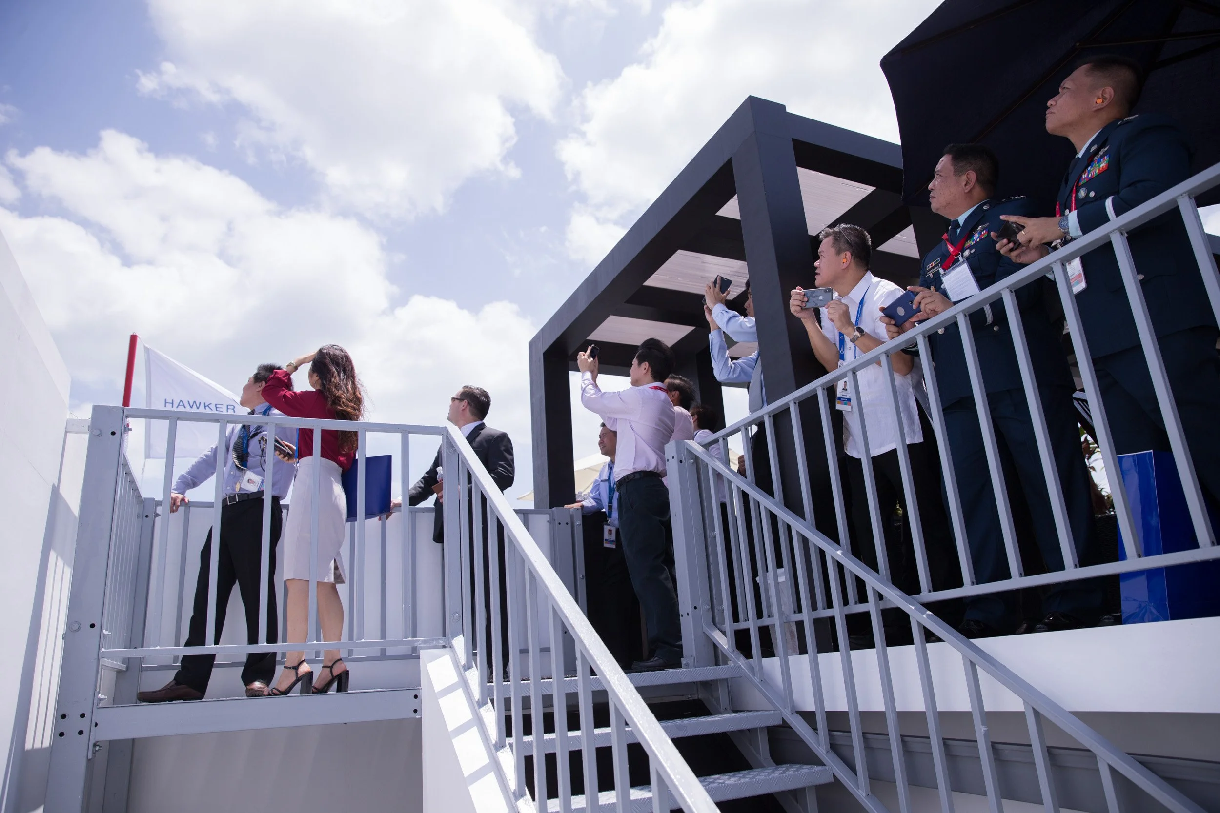  Hawker Pacific guests watching Singapore Airshow 2018 aerobatic performances from the chalet balcony. 