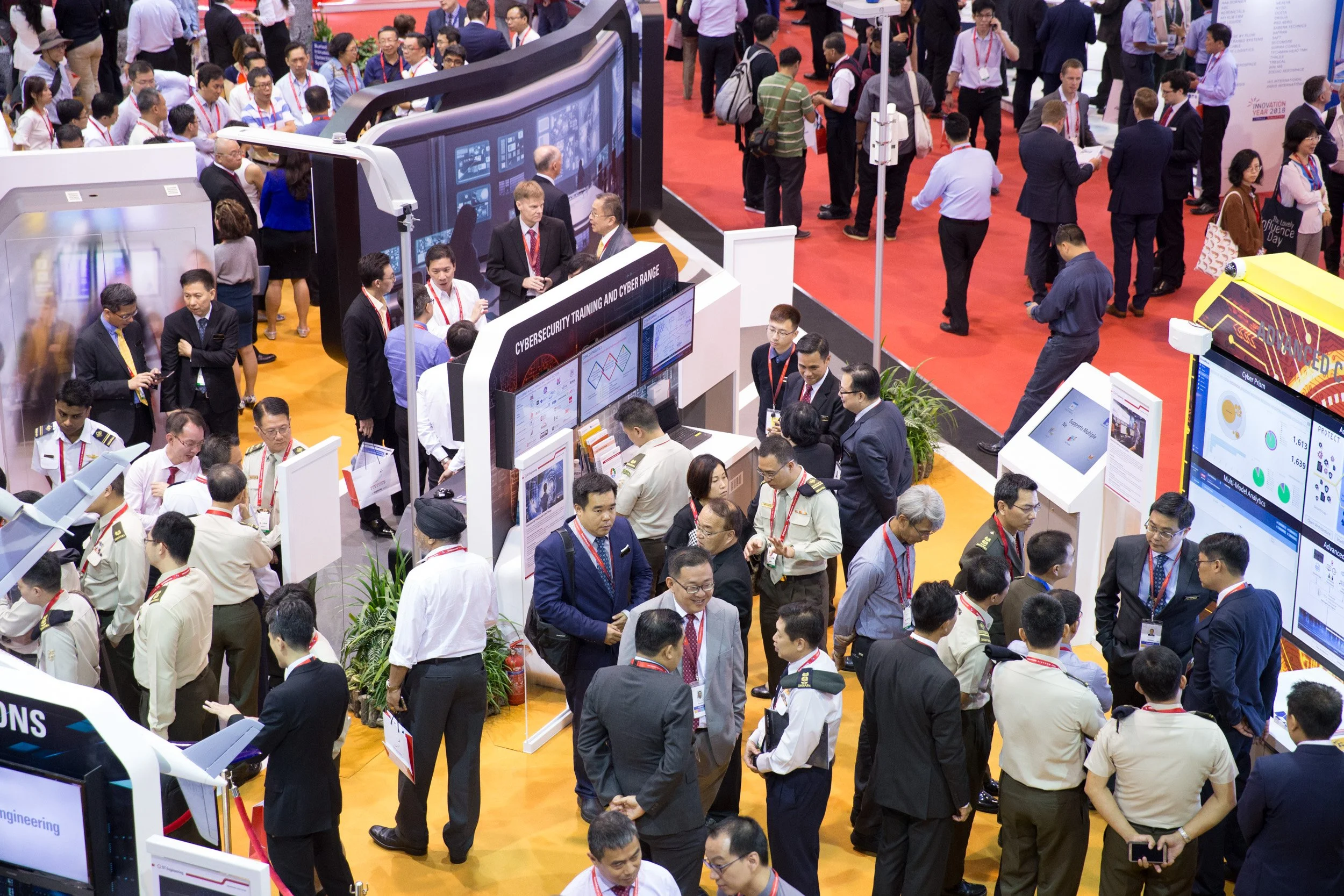  Elevated second-tier perspective of busy trade floor visitor traffic inside Changi Exhibition Centre. 