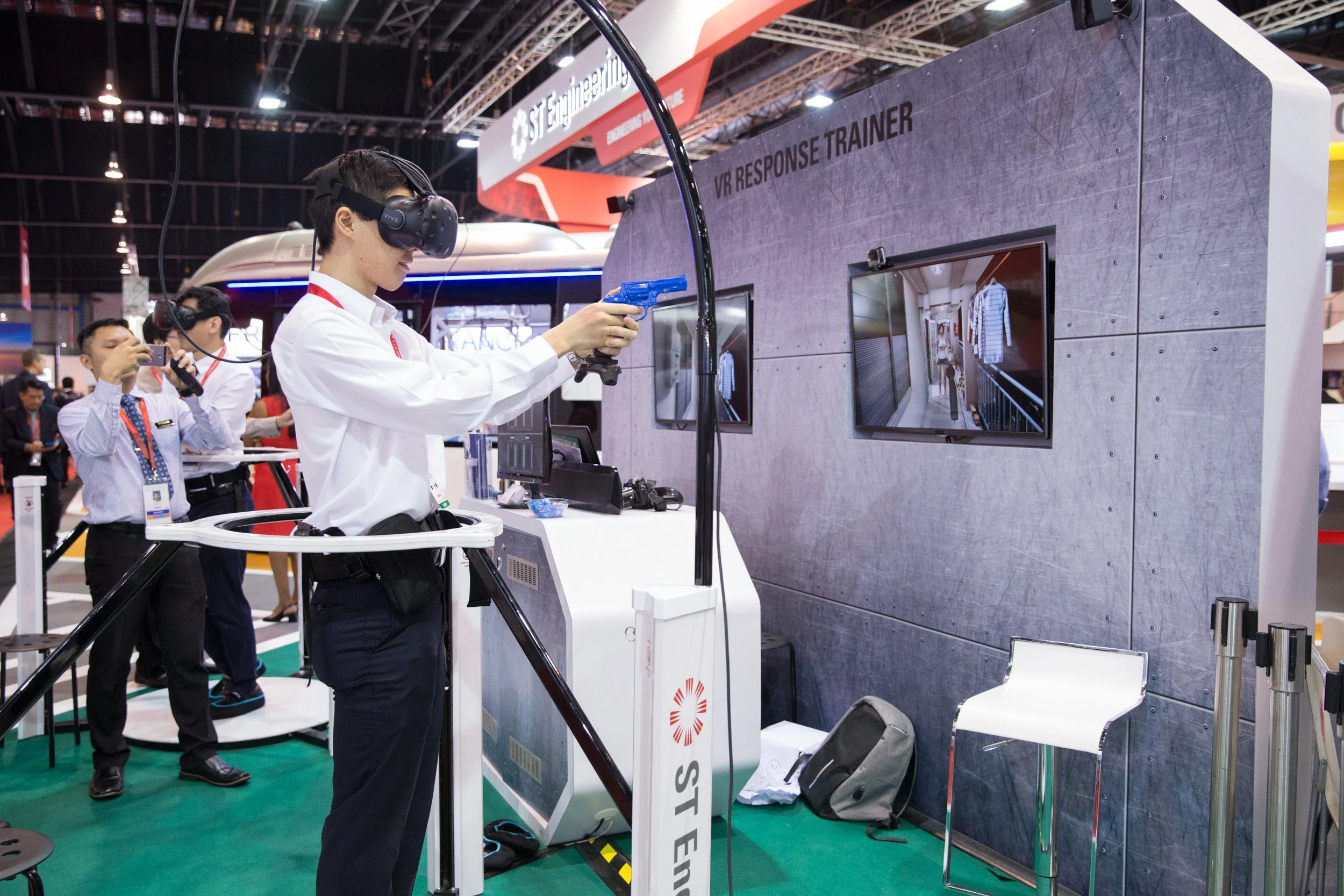  Event attendee testing the ST Engineering VR Response Trainer headset at the defense technology pavilion. 