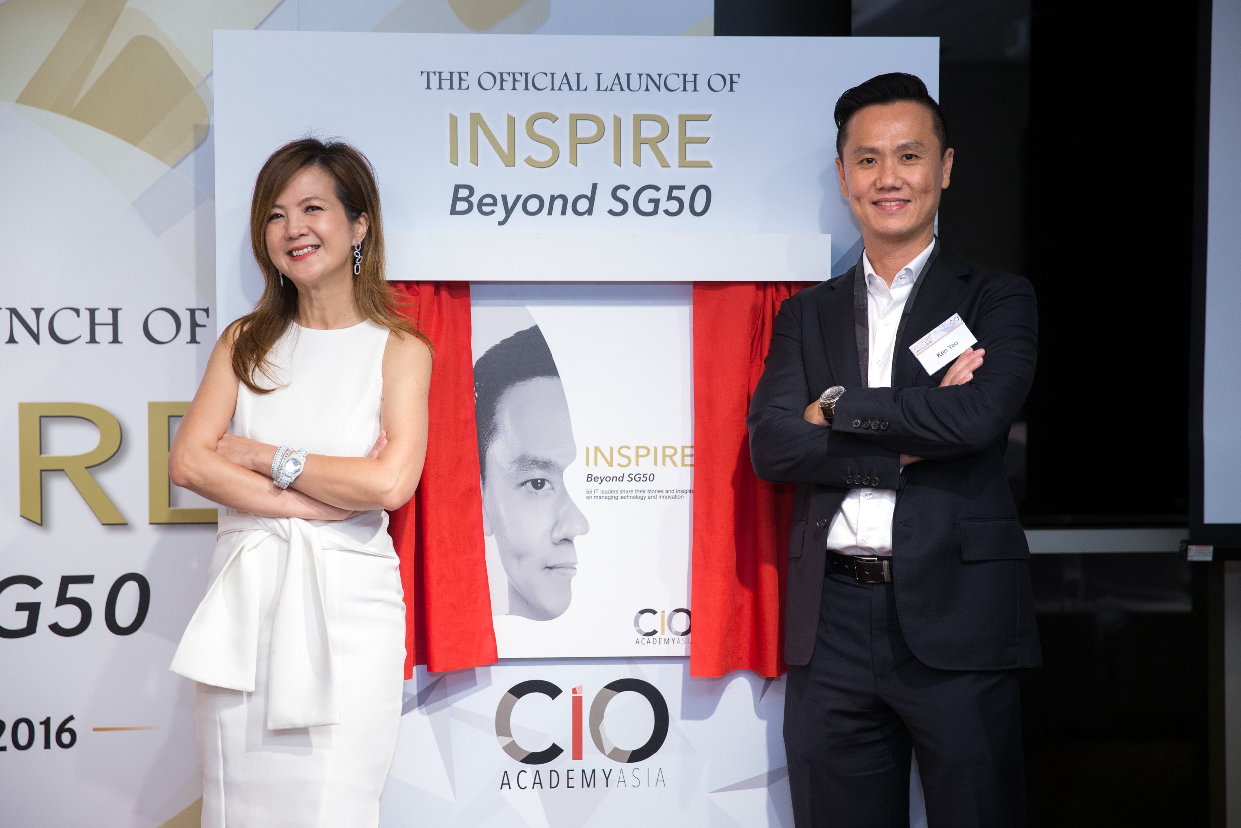  Featured CIO leaders posing in front of the official "Inspire Beyond SG50" book cover display poster. 