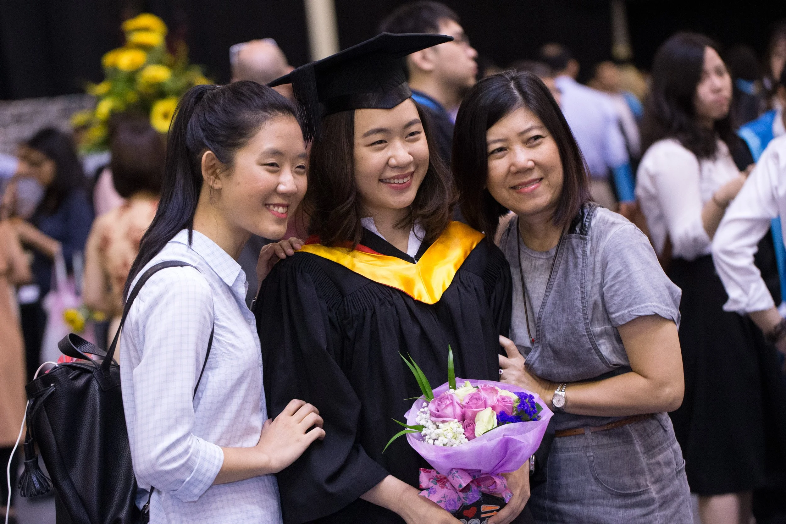  Candid family photograph with a female LASALLE graduate celebrating her academic achievement. 