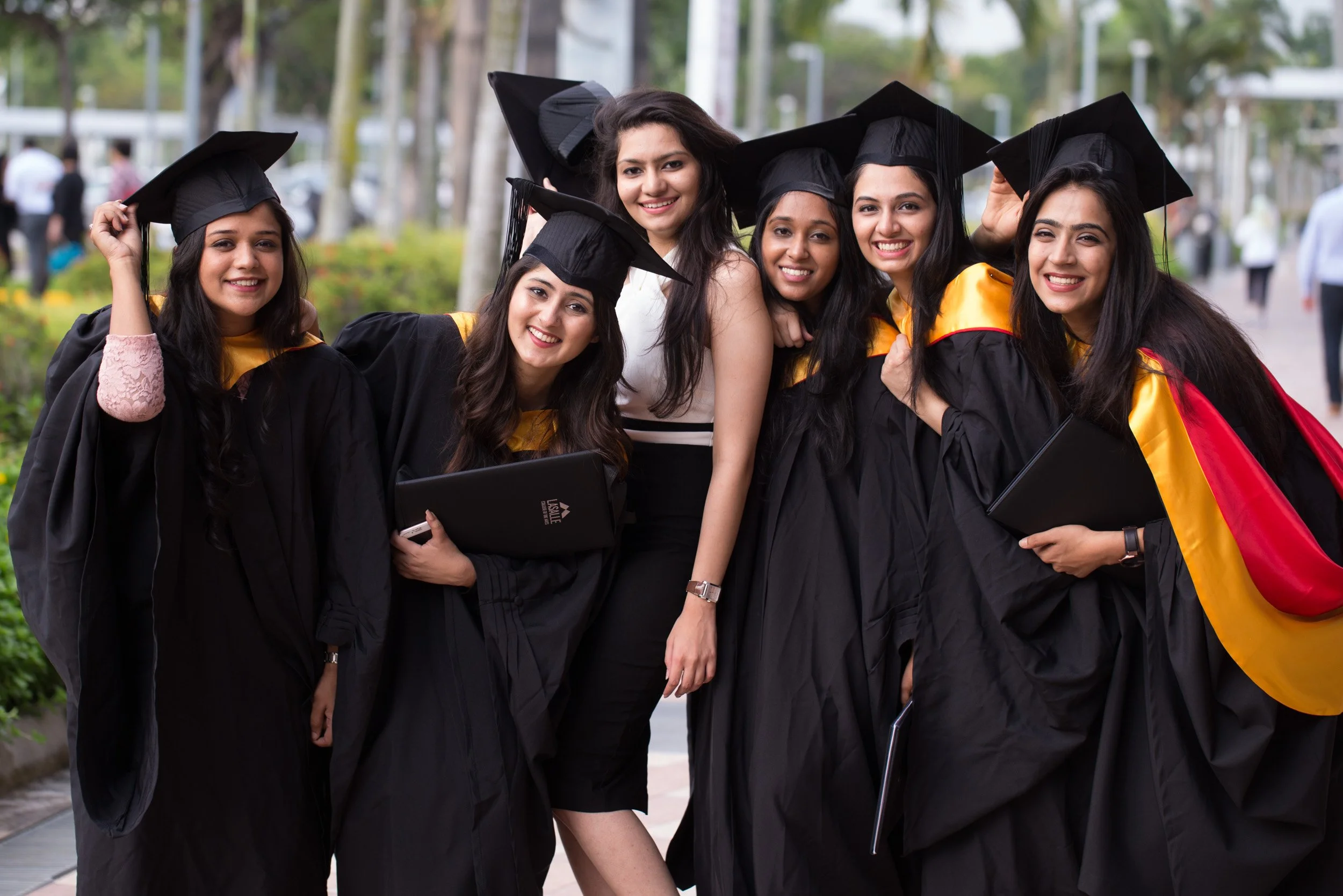  Group portrait of female graduates posing outdoors at Singapore EXPO. 