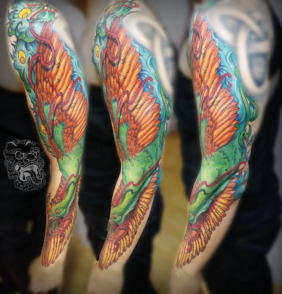 The idea behind this full color phoenix tattoo was to create an effect of the big wing along with Phoenix image. That way what viewer sees first is a big shape, and then when he approaches closer - the detail is visible.