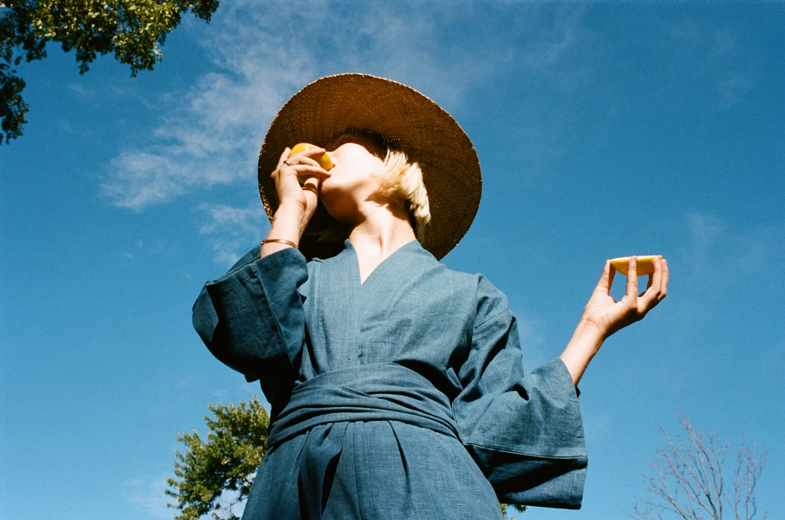 MOMO IS EATING A LEMON, A RISKY BEHAVIOR WHILE WEARING AN INDIGO ROBE...