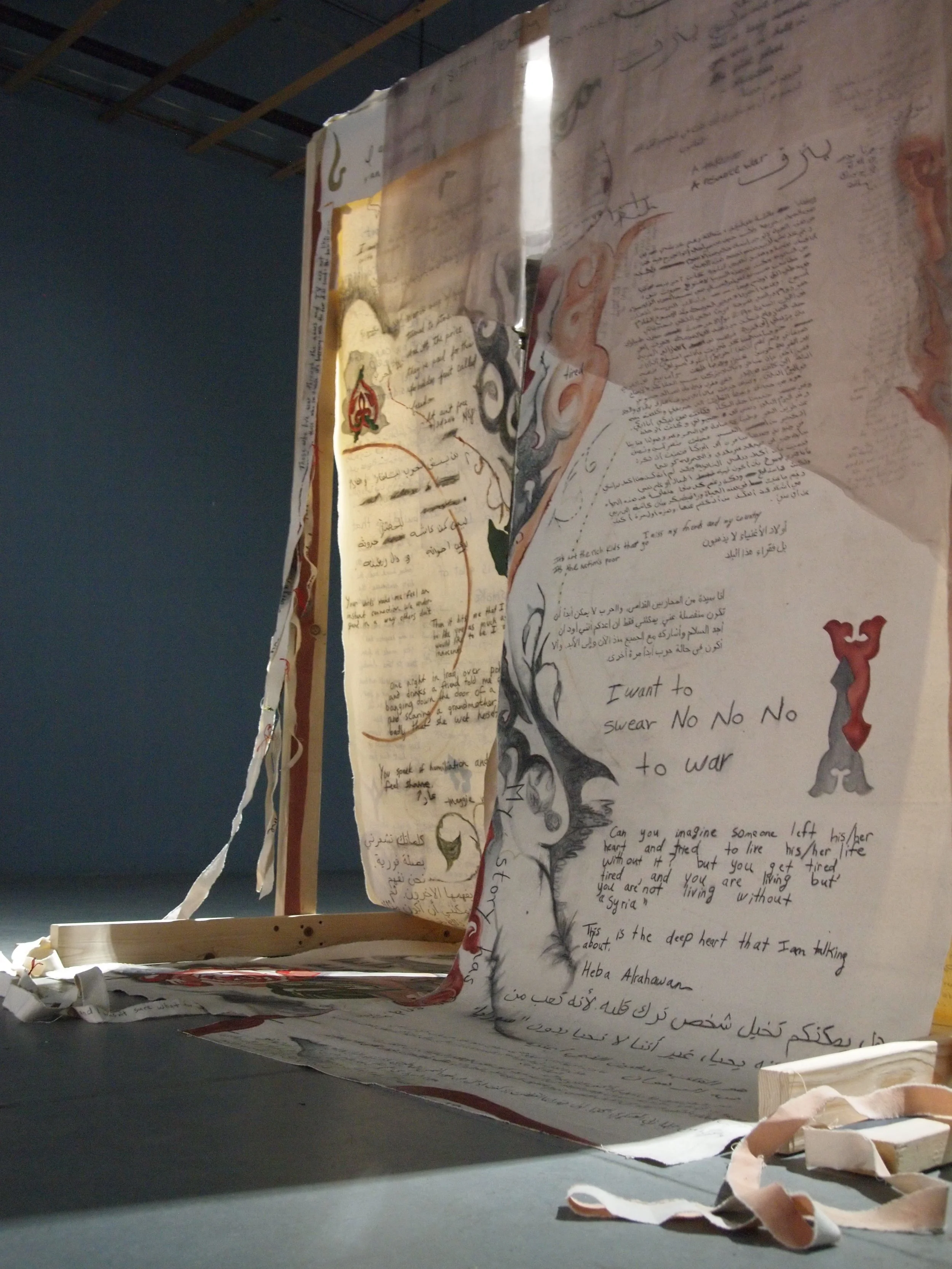 The Khayamiyya Monument, 2017, Canvas, charcoal, acrylic, wood, paint, string, organza, collected personal writings by female im/migrants and U.S. veterans, community workshops, community open mics, 7 ft tall x 6.5 ft wide x 4.5 ft deep Photo cred