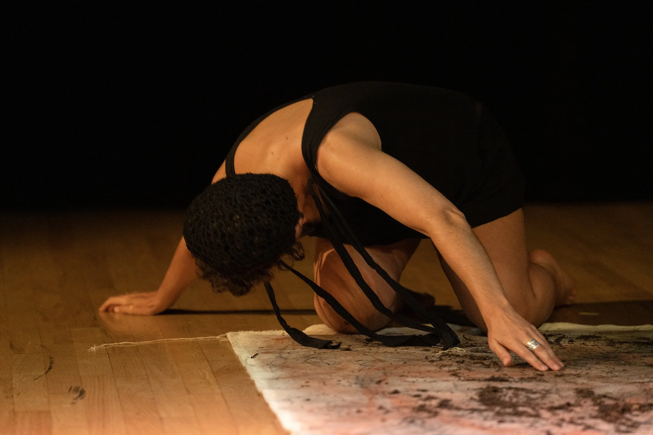 not a performance, 2025, 6 min, participatory performance with original writing as recorded sound, canvas, dirt, paper pulp figure, fabric This moment had the accompanying audio of my voice saying “Entire family lines, wiped out.” Photo by Manue