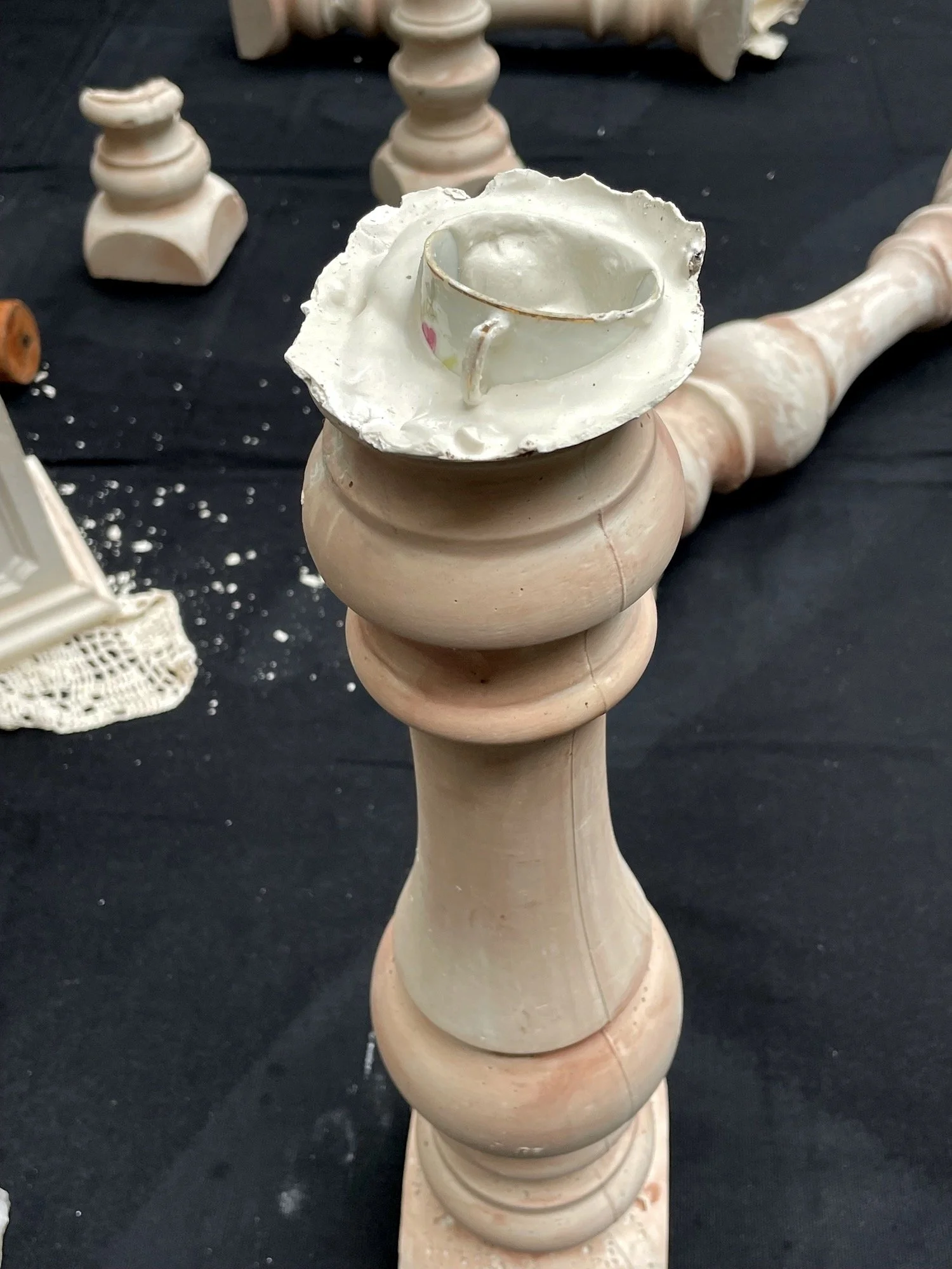 Detail shot of teacup embedded in plaster Photo by Katherine Toukhy