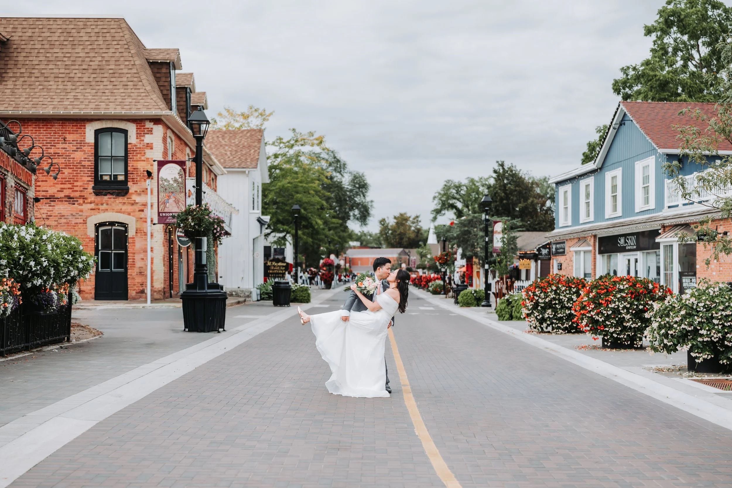 wedding-photography-Bride-and-Groom-kiss-on-Main-Street-Unionville-maple-and-clover.jpg