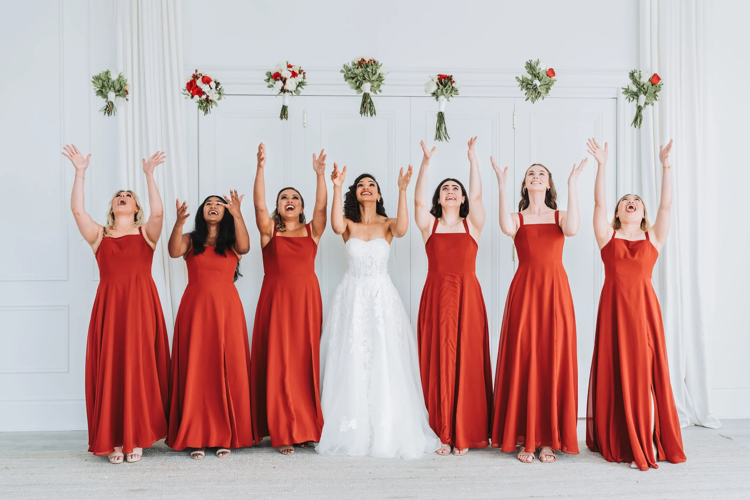 Documentary-style wedding photography of a bride and bridesmaids celebrating together indoors at the Mint Room Studios in Toronto, by Maple & Clover.