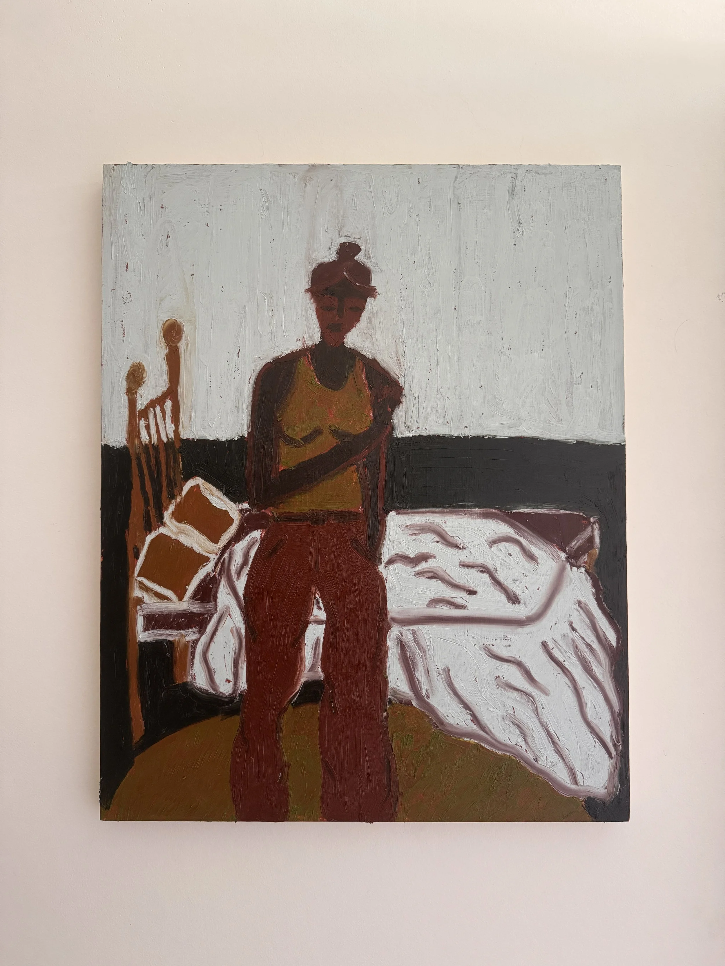 An abstract painting of a woman with dark skin, short hair, wearing a yellow top and red pants, sitting in a room with a white wall and a table with a white cloth.