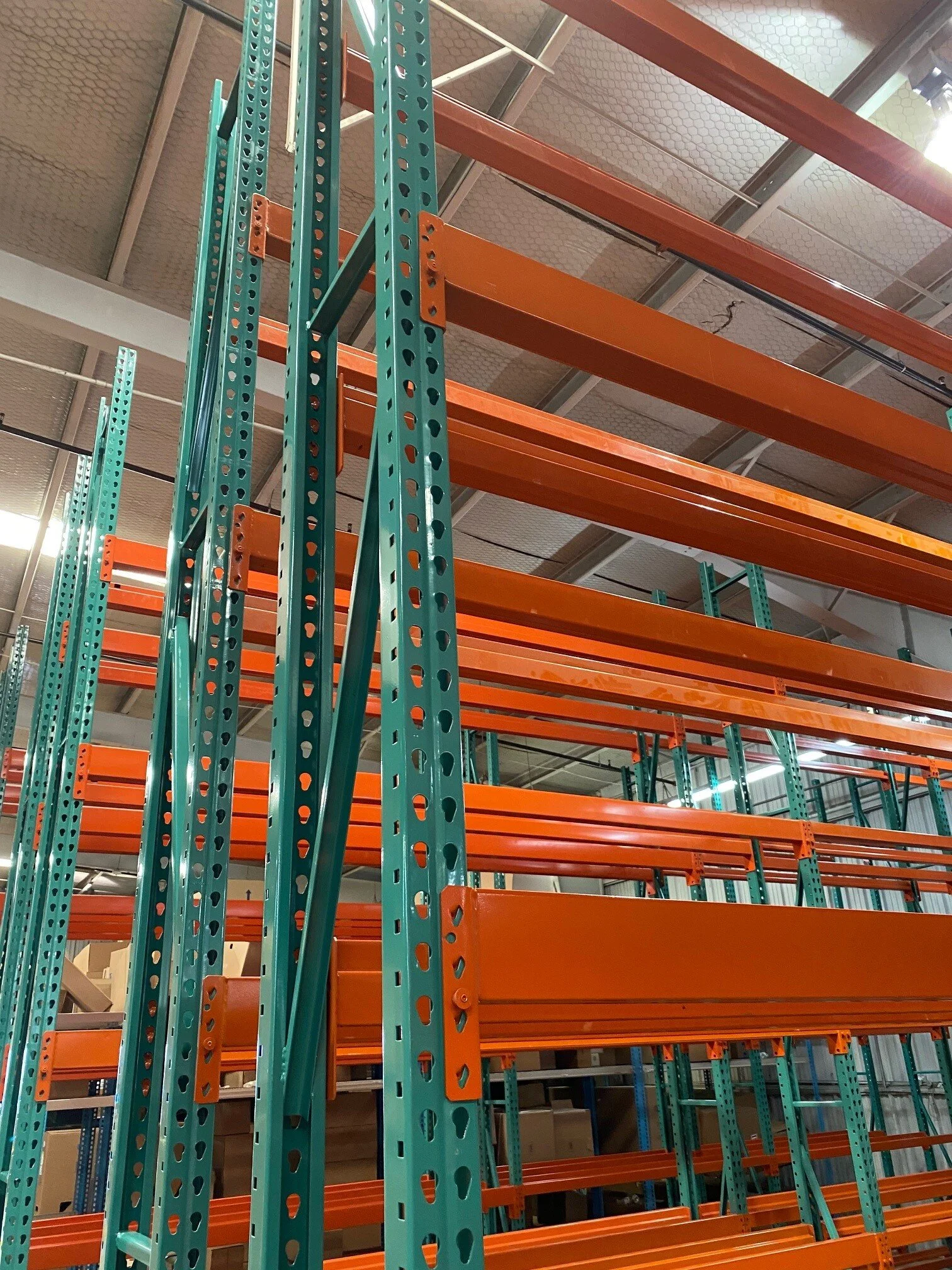 Empty pallet rack system with orange uprights.jpg