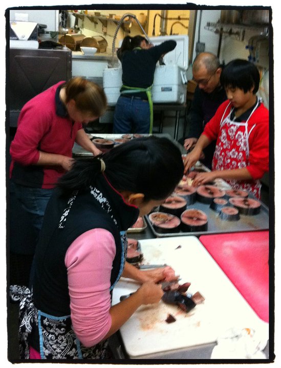 June Lee (bottom left), Philip Lee (top right), Amy Grondin (top center) skinning and cleaning albacore.