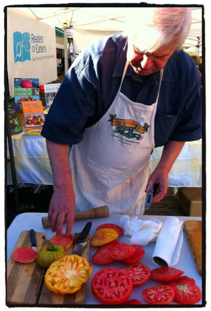 Jon Rowley demonstrating how to use a refractometer to gauge the level of sugars in tomatoes.