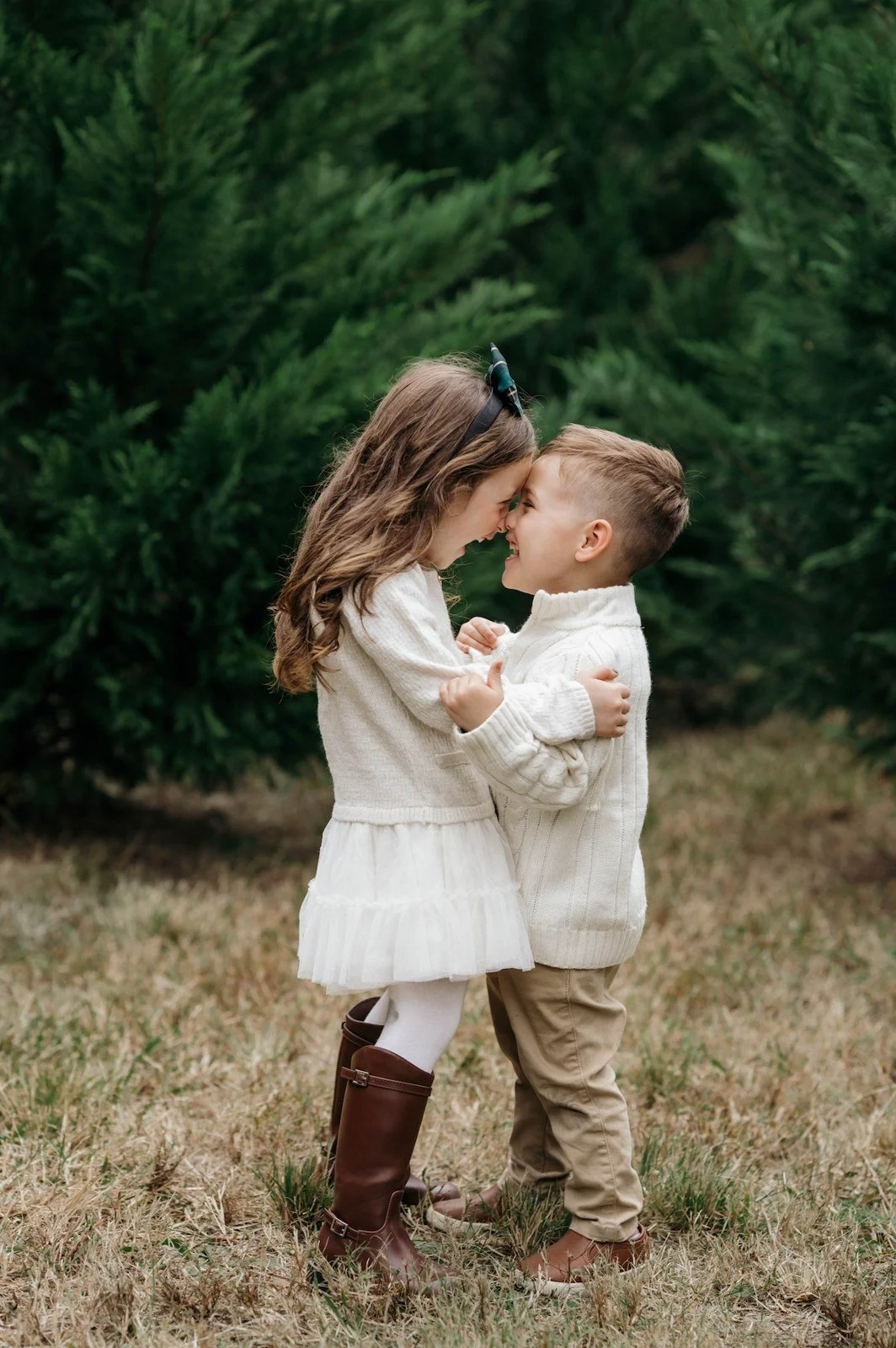 Kids laughing at a Christmas mini session at a tree farm in Chapin, SC