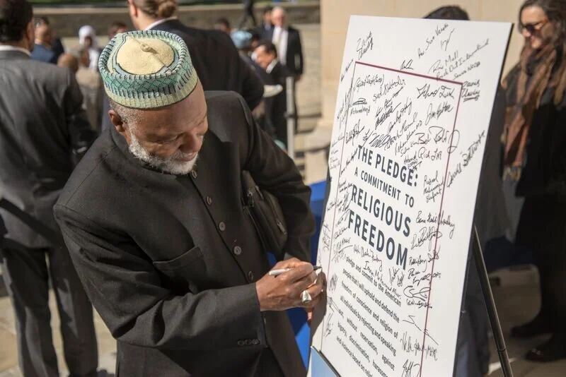 Imam Johari signing pledge.jpeg