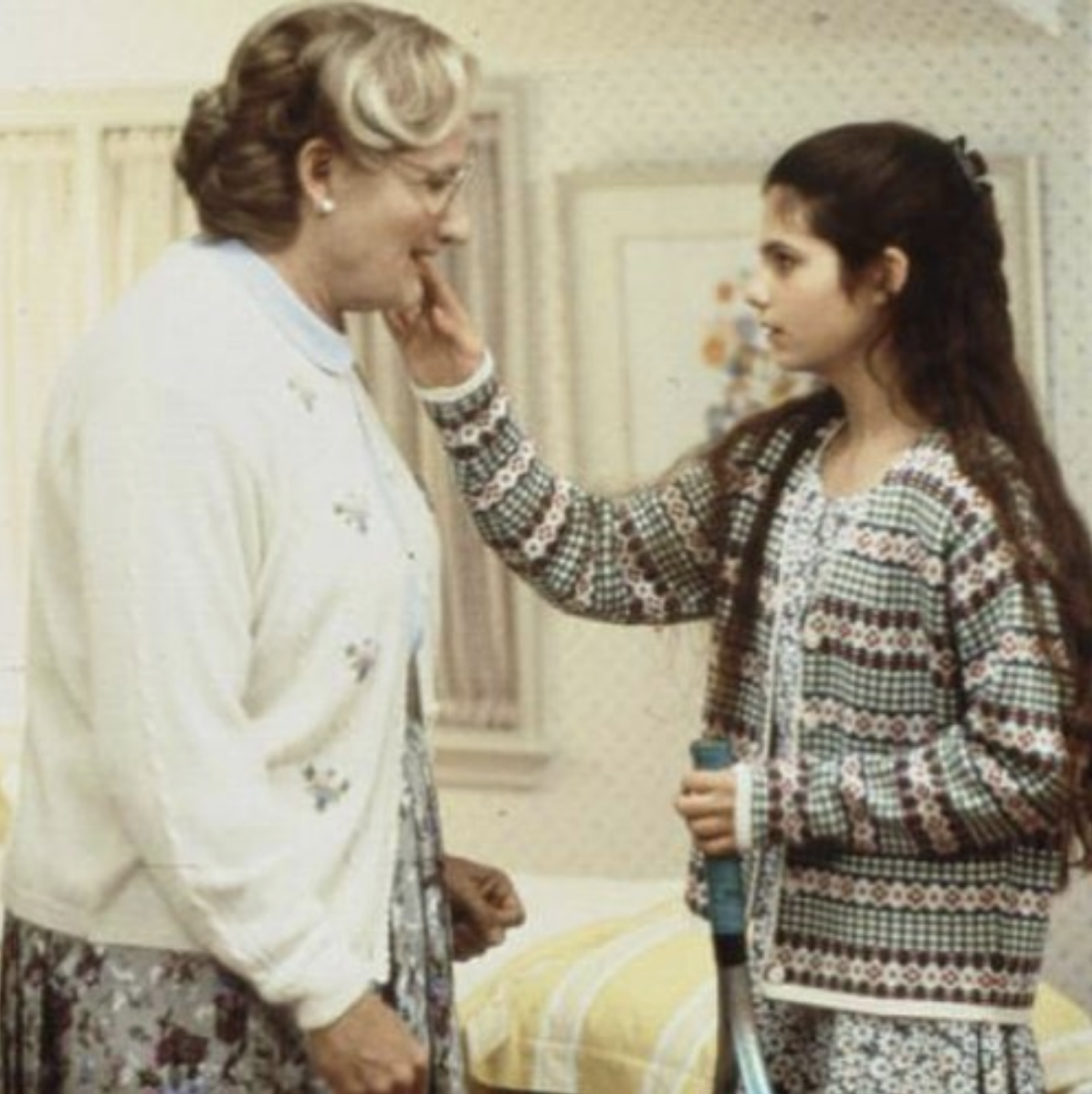 Lisa Jakub touches Robin William's face, as he is dresses as Mrs. Doubtfire.