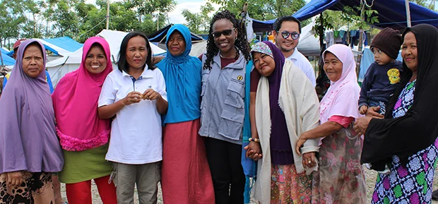 Josephine (center, in CWS vest) with community members in Central Sulawesi, Indonesia. Rev. Vy Nguyen, Executive Director of Week of Compassion, is also pictured (center, in a white shirt).