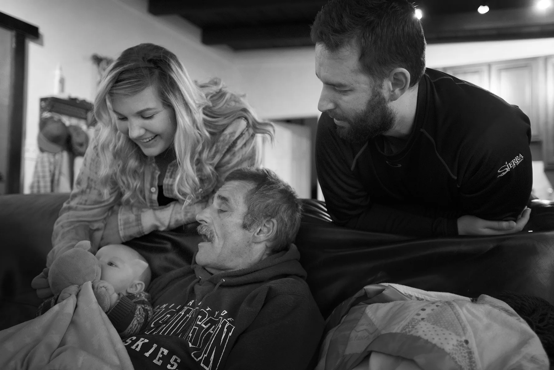 Steve with his son Chad, daughter-in-law Alli and holding his grandson Brett during a Christmas time visit.