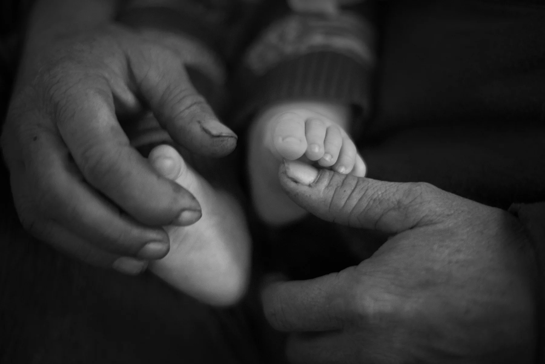 "I used to play with Chad's feet like this for hours when he was a baby," said Steve, as he cradles his grandson's feet.
