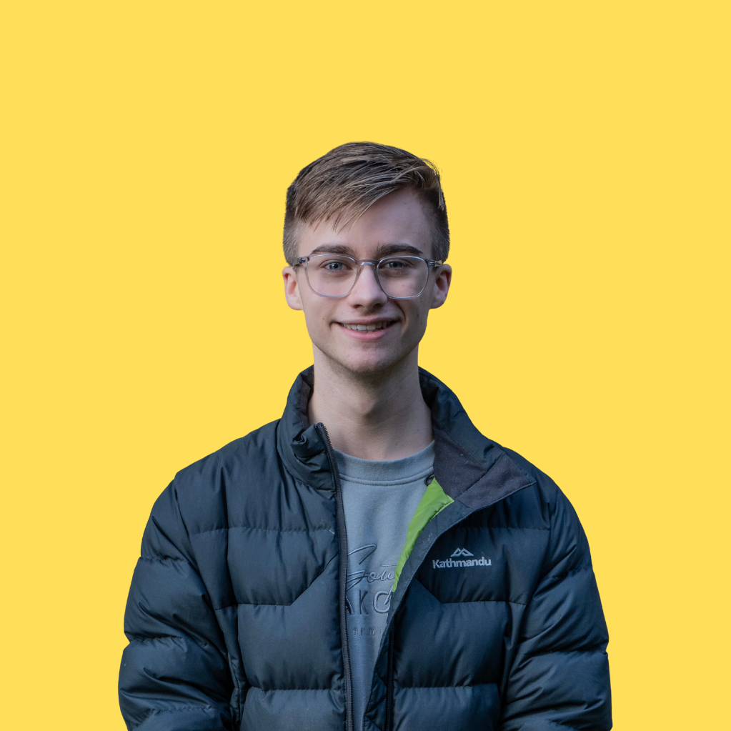 Image of Marty Davies smiling slightly on a yellow background