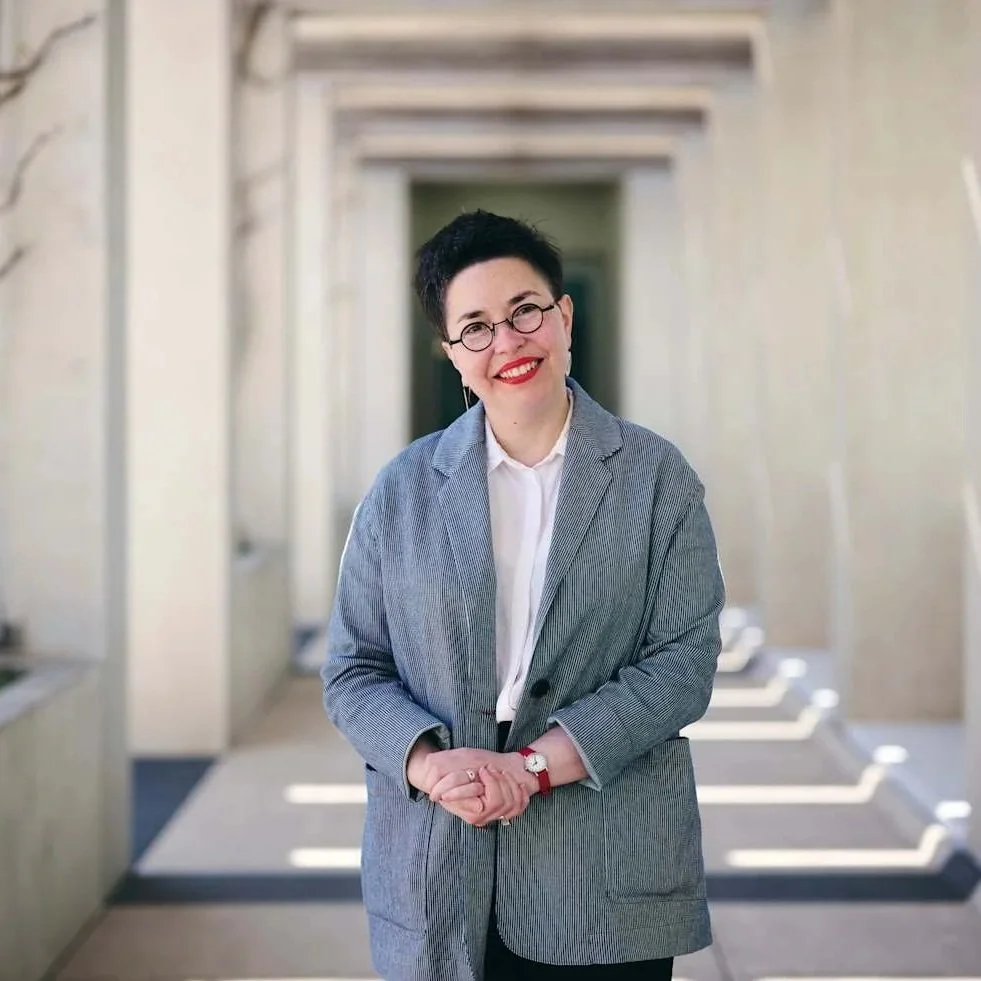 an image of Esther standing outside smiling