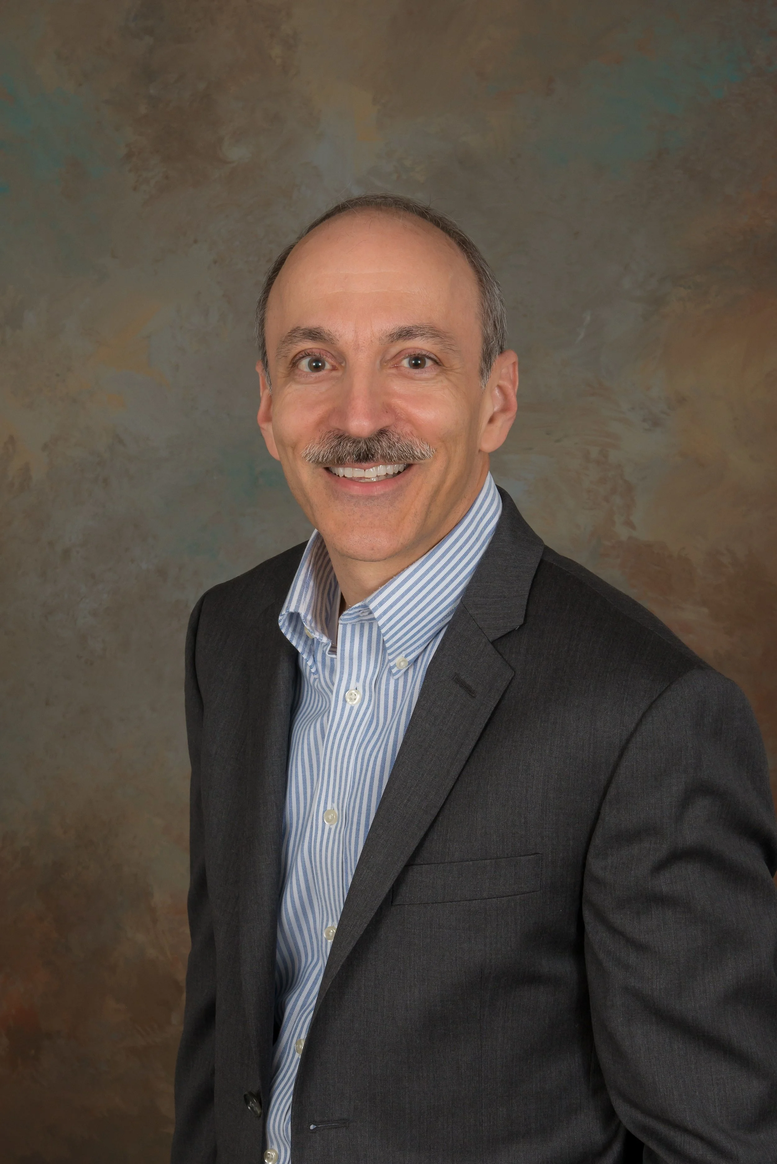 Professional portrait of Adam Lawrence, founder of Process Improvement Partners, Kaizen facilitator, Lean manufacturing expert, and creator of the Wheel of Sustainability.