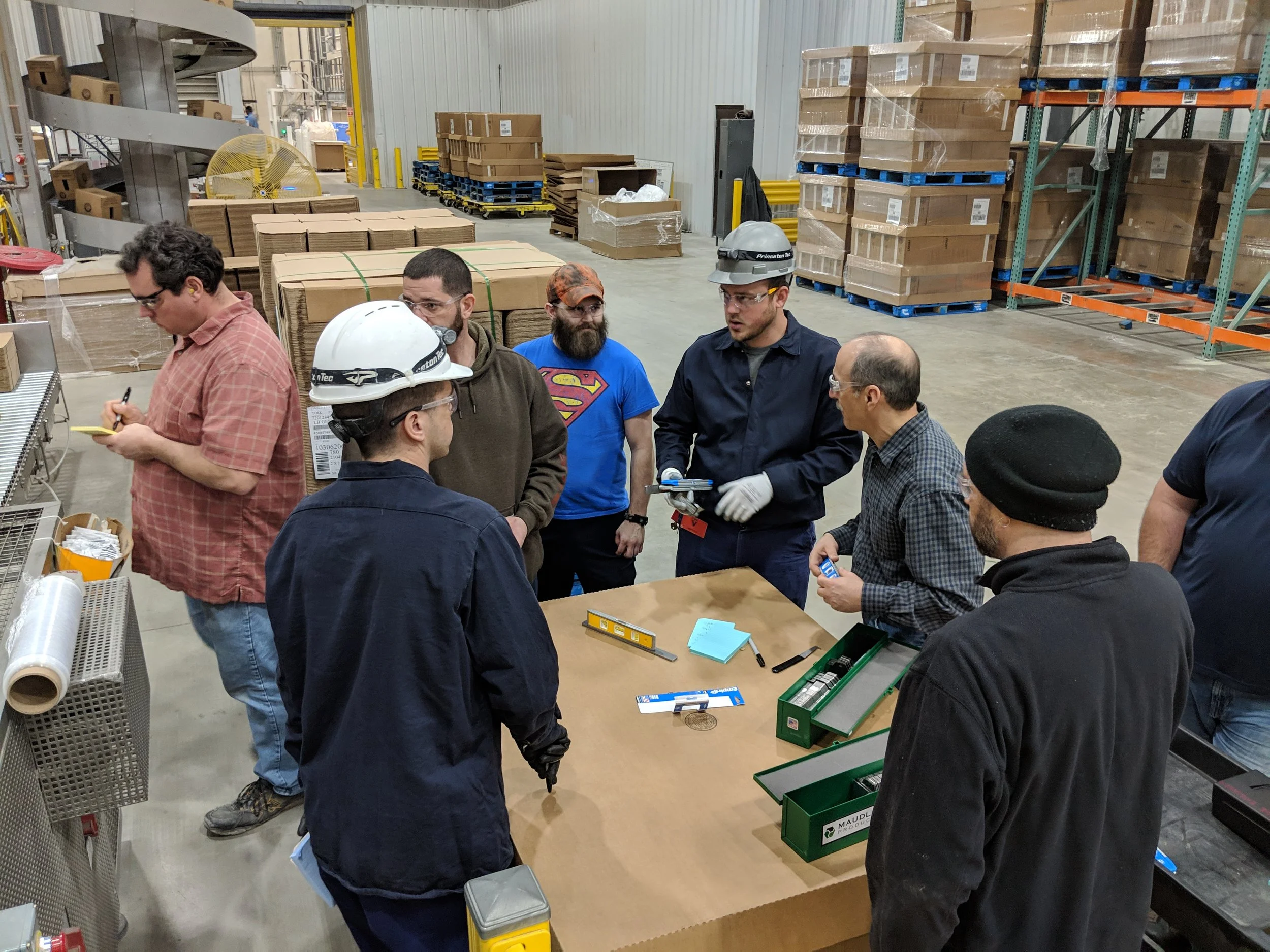 Adam Lawrence, owner of Process Improvement Partners LLC, based in Lancaster Pennsylvania, working with a team in a manufacturing plant, identifying high-value improvement opportunities