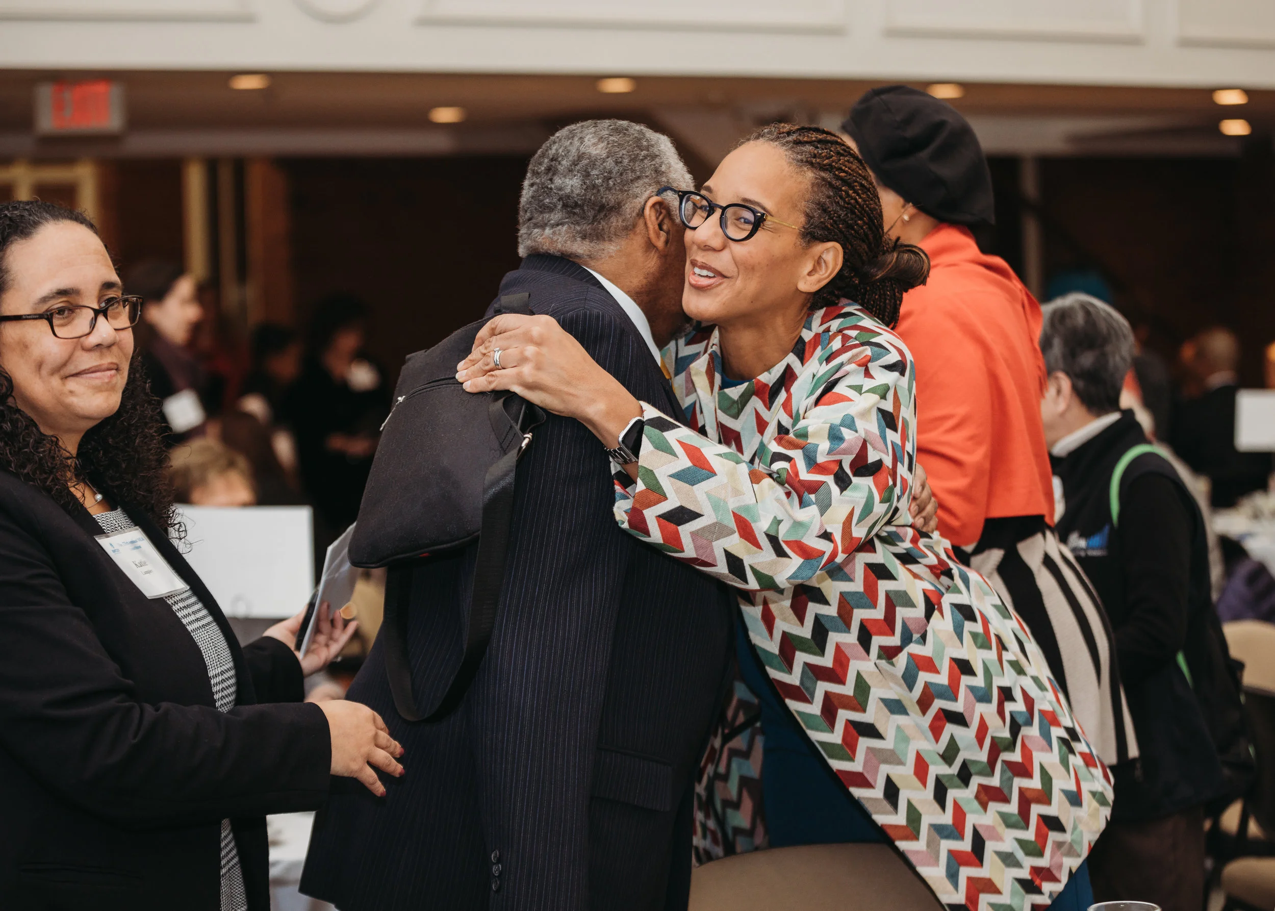 Earl Avery greeting friends and family at the MLK Luncheon/retirement celebration. Boston photographer Joy LeDuc. Capturing emotion at corporate events.