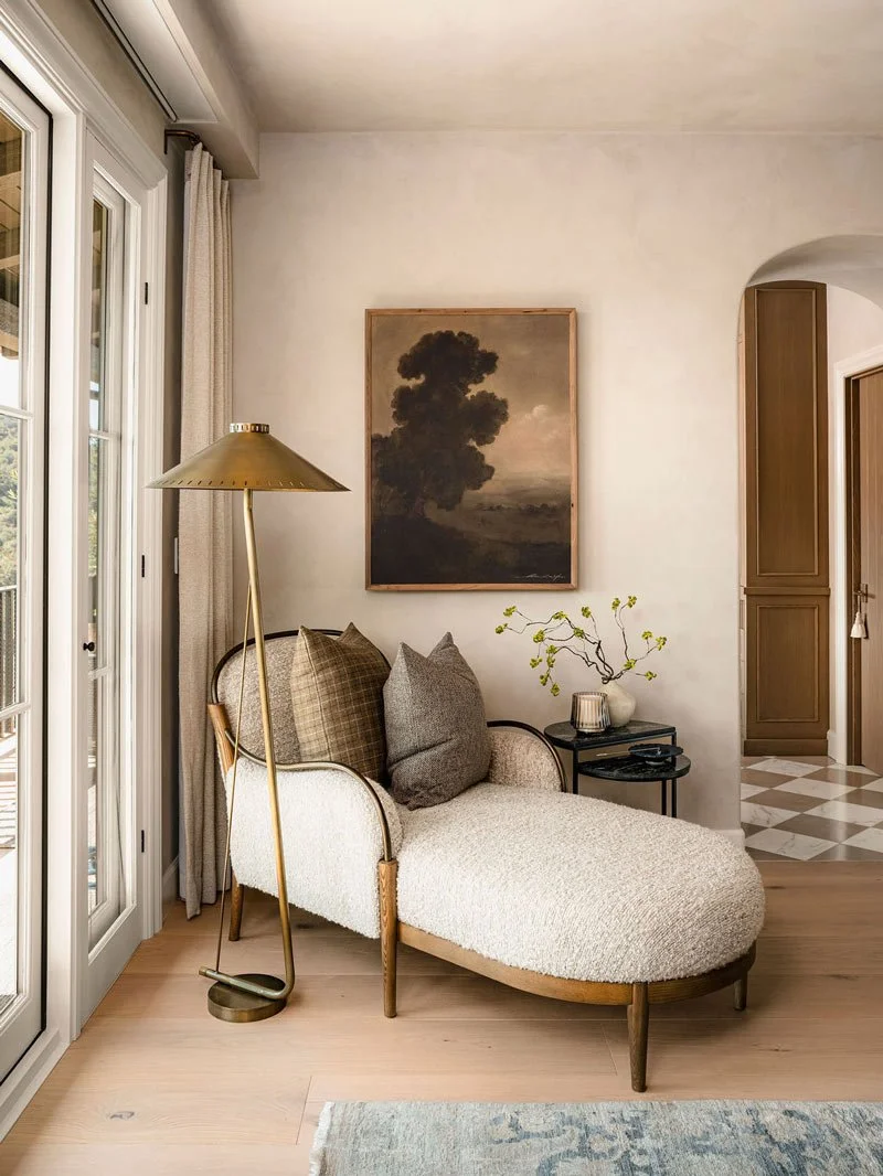 A cozy living room corner with a chaise lounge, two pillows
