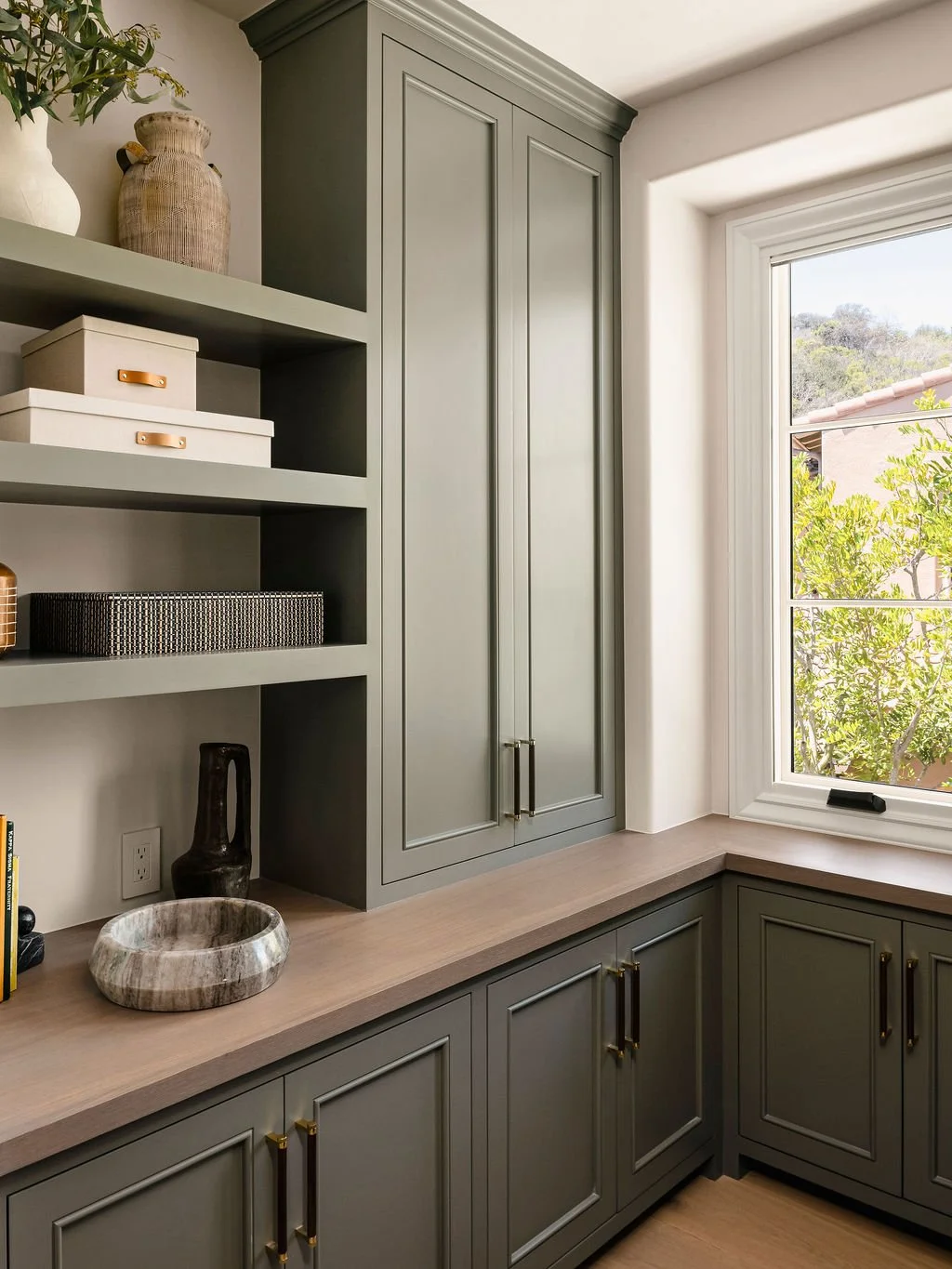 Pantry area with sage green cupboards