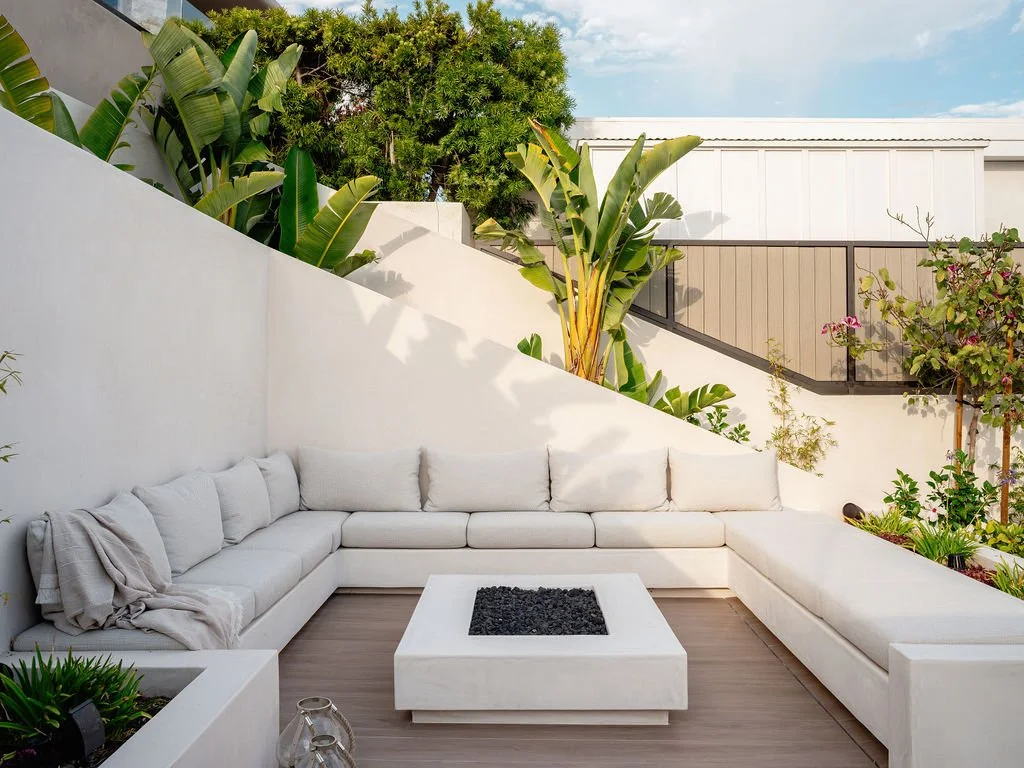 White outdoor seating area with firepit