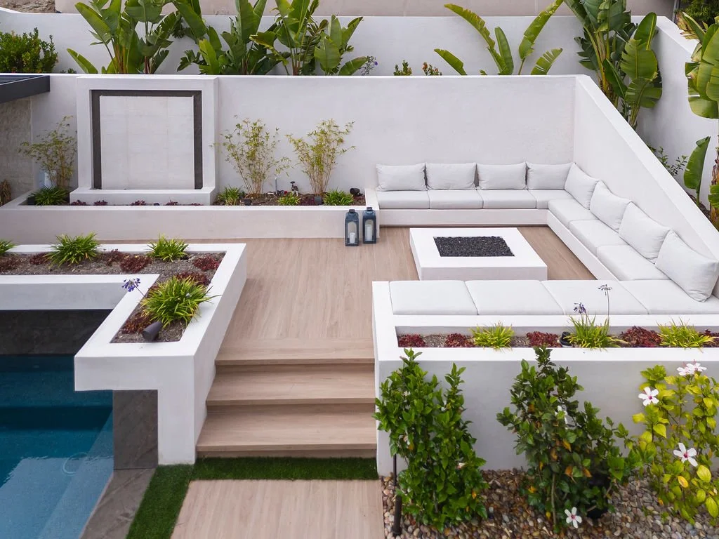 Large outdoor white seating area with plants