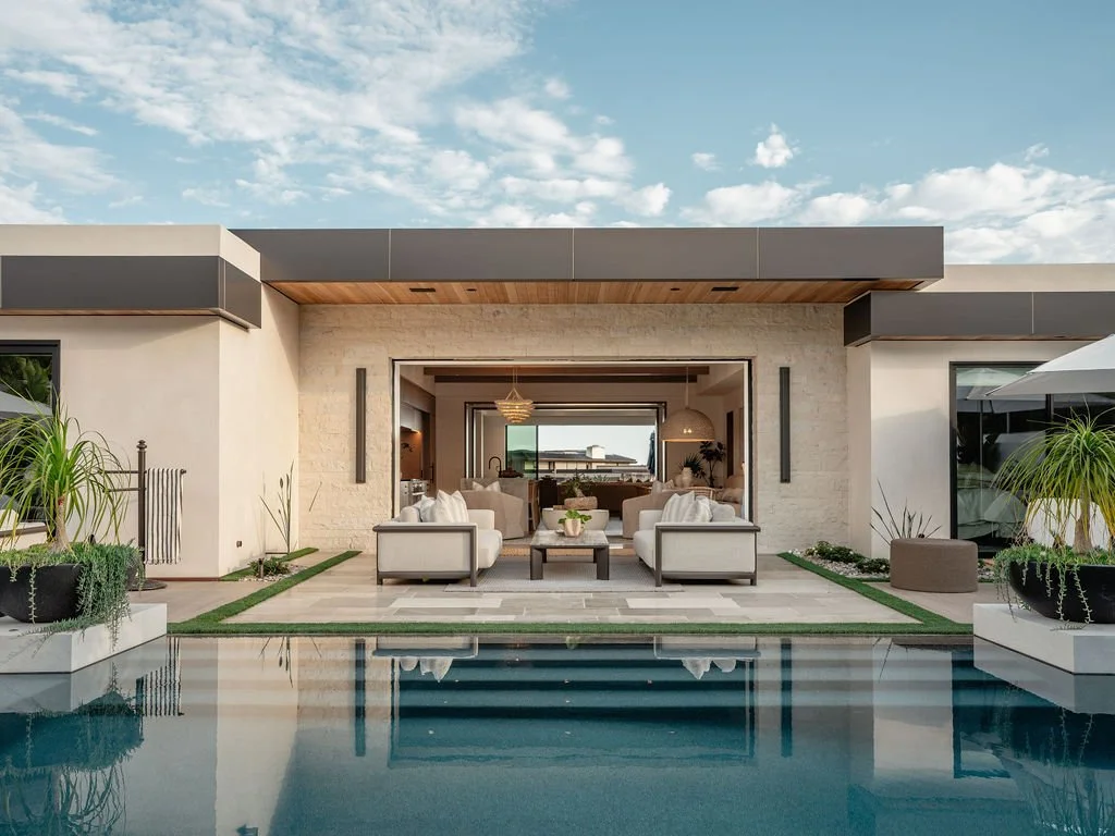 Indoor/outdoor lounge area next to pool