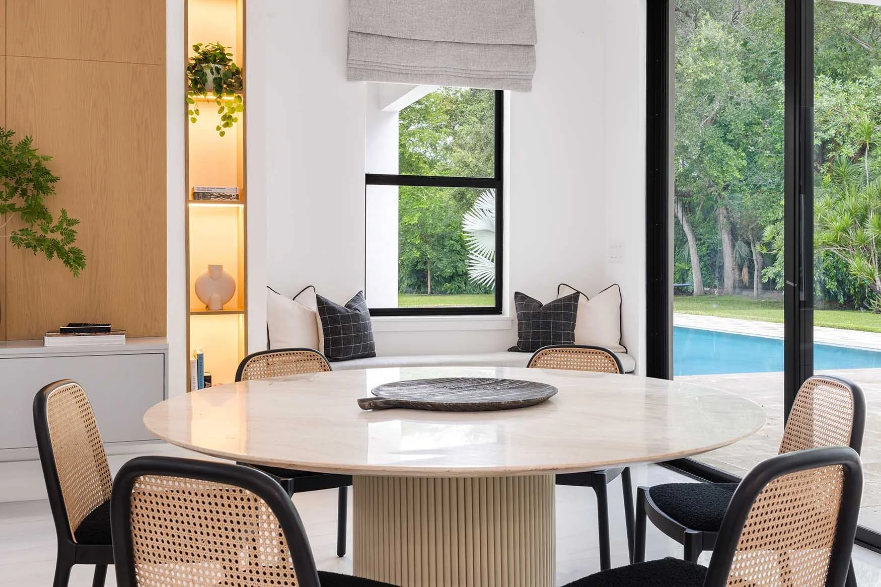 Contemporary dining room with custom millwork and wood panel finishes