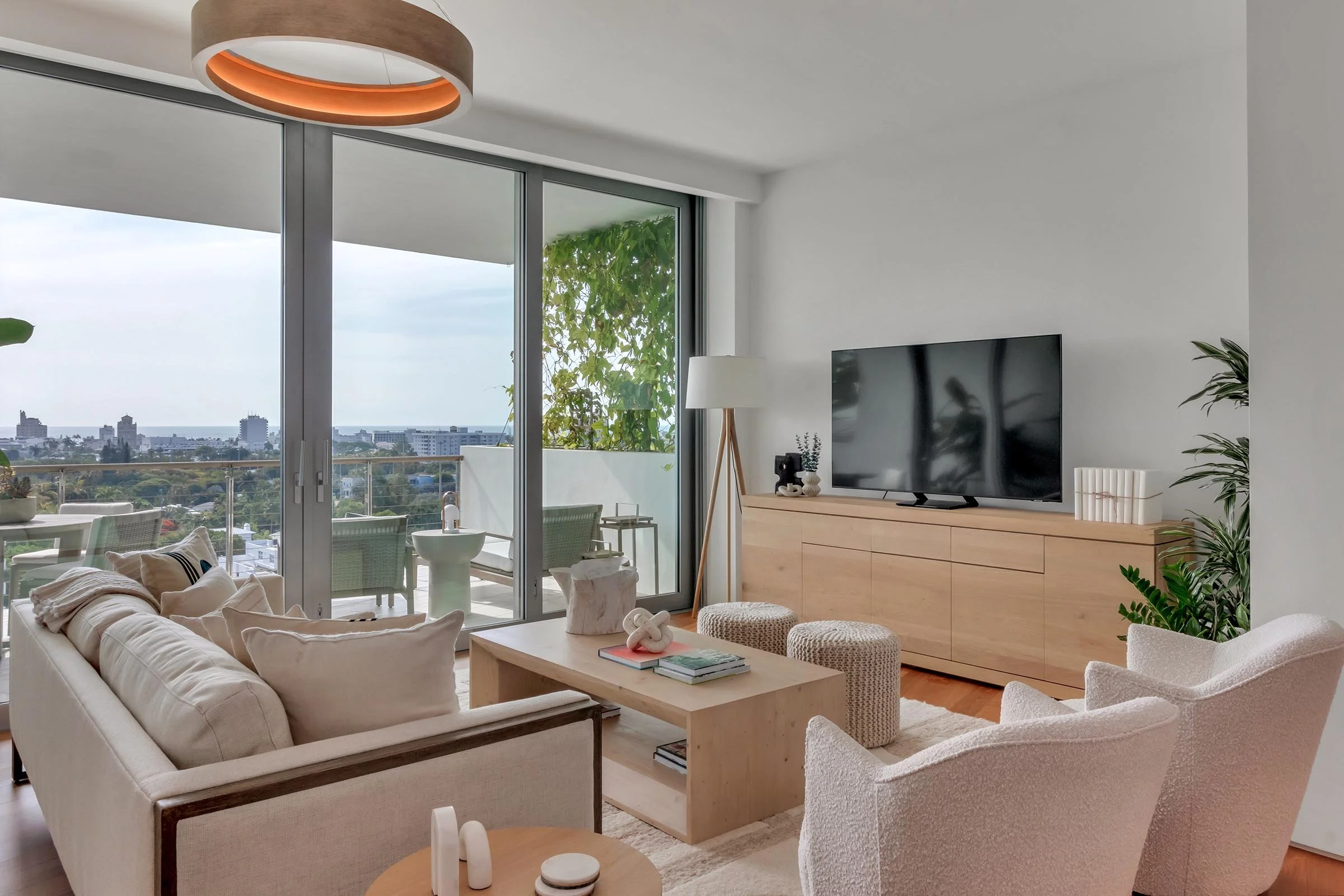 Sunlit living room with organic textures and soft fabrics in a Monad Terrace South Beach residence, reflecting Miami’s ‘New Miami’ style.