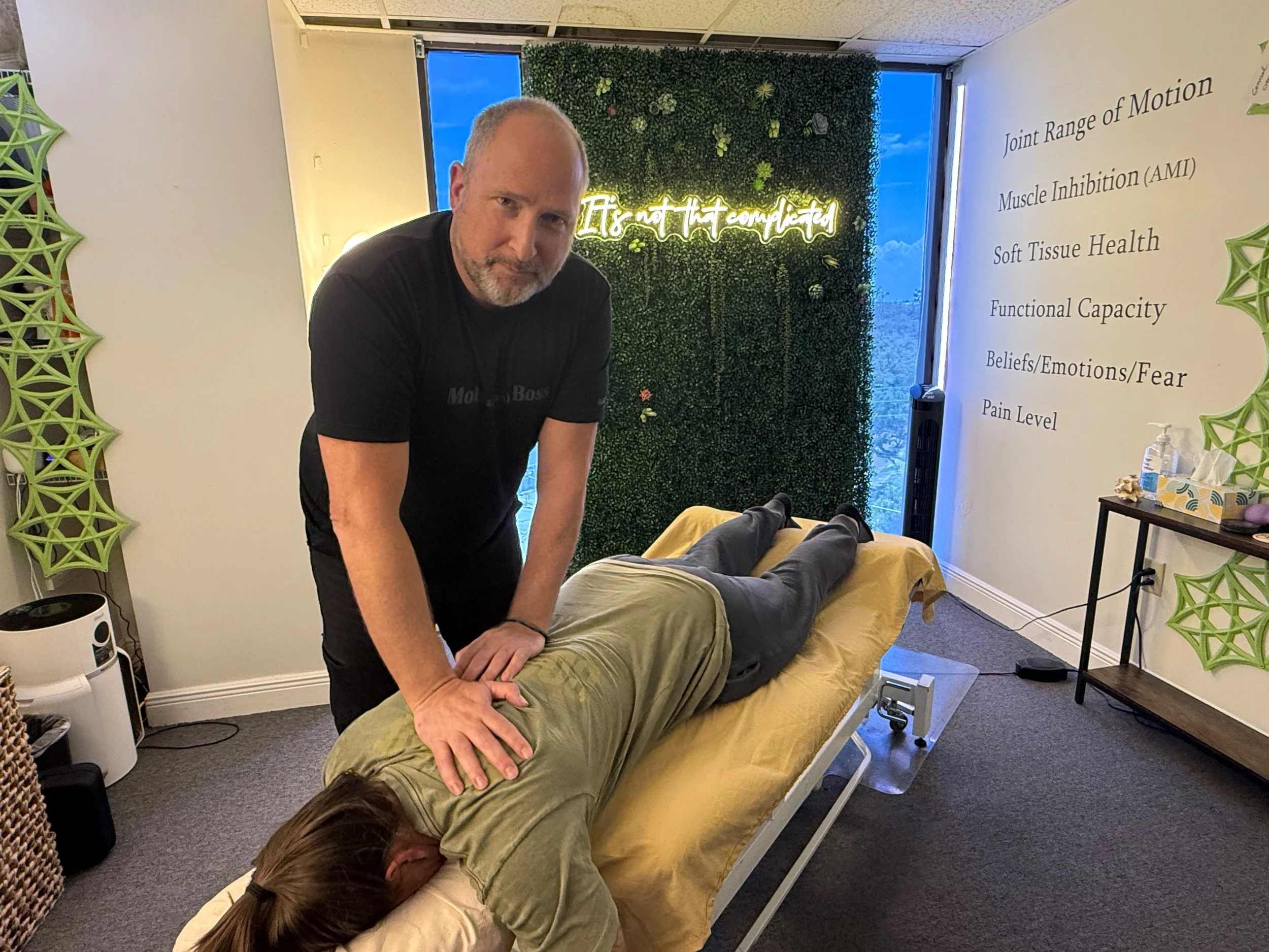 eran kabakov doctor of physical therapy treating a patient on a table inside a clinic