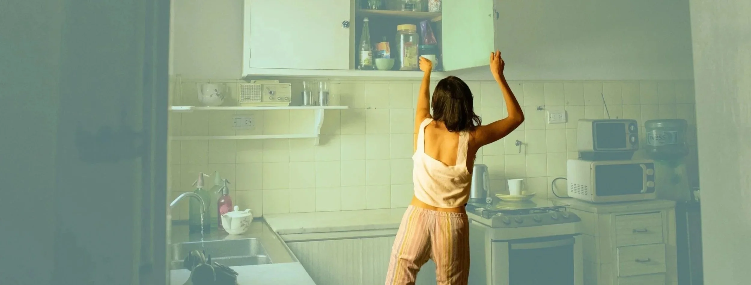 reaching_into_cupboard