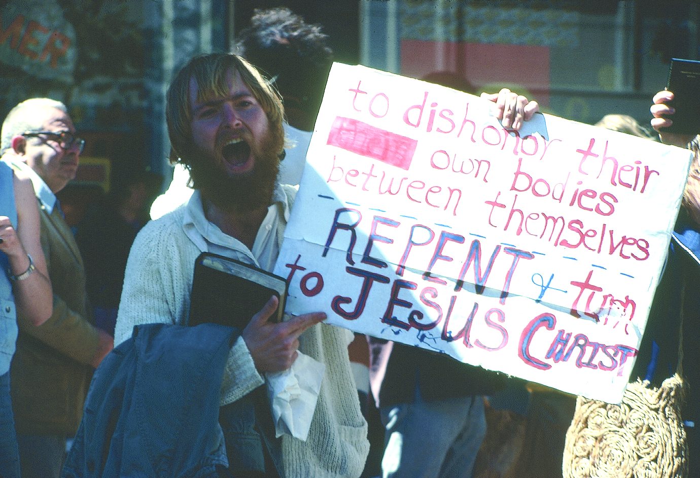  Man holding a sign that reads “To dishonor their own bodies between themselves. Repent and turn to Jesus Christ,” Gay Freedom Day Parade, 1978; photograph by Crawford Barton, Crawford Barton Papers (1993-11), GLBT Historical Society.  At every pride